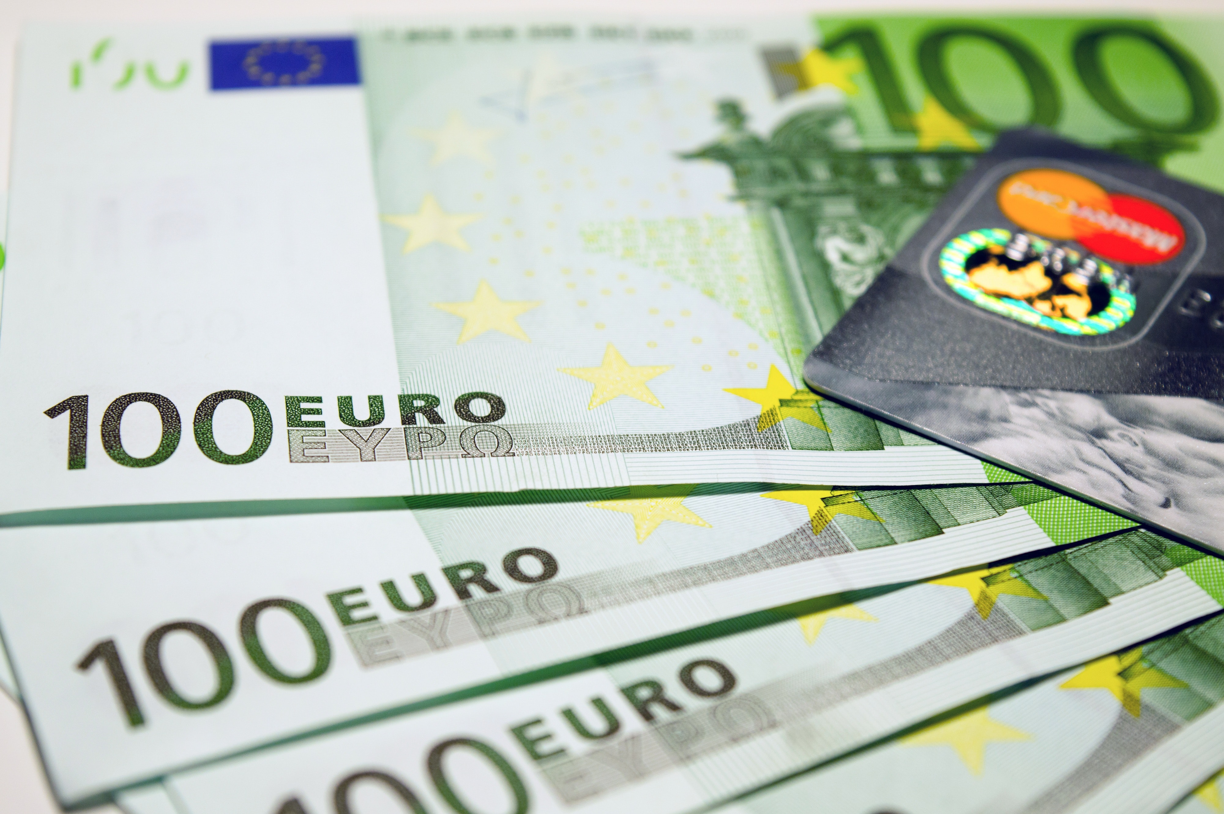 100 euro bills beside mastercard photo