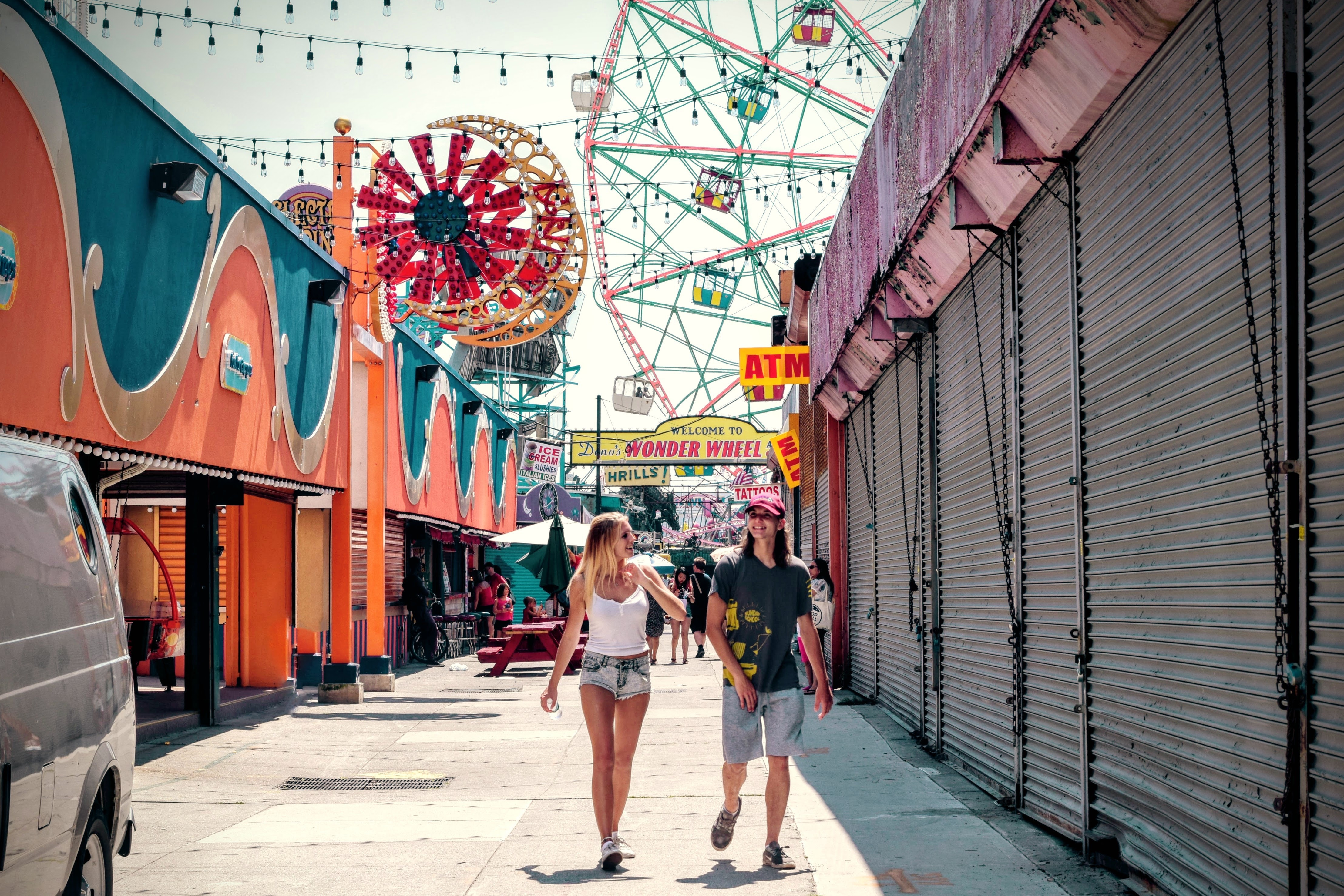 2 women walking in the carnival during daytime photo