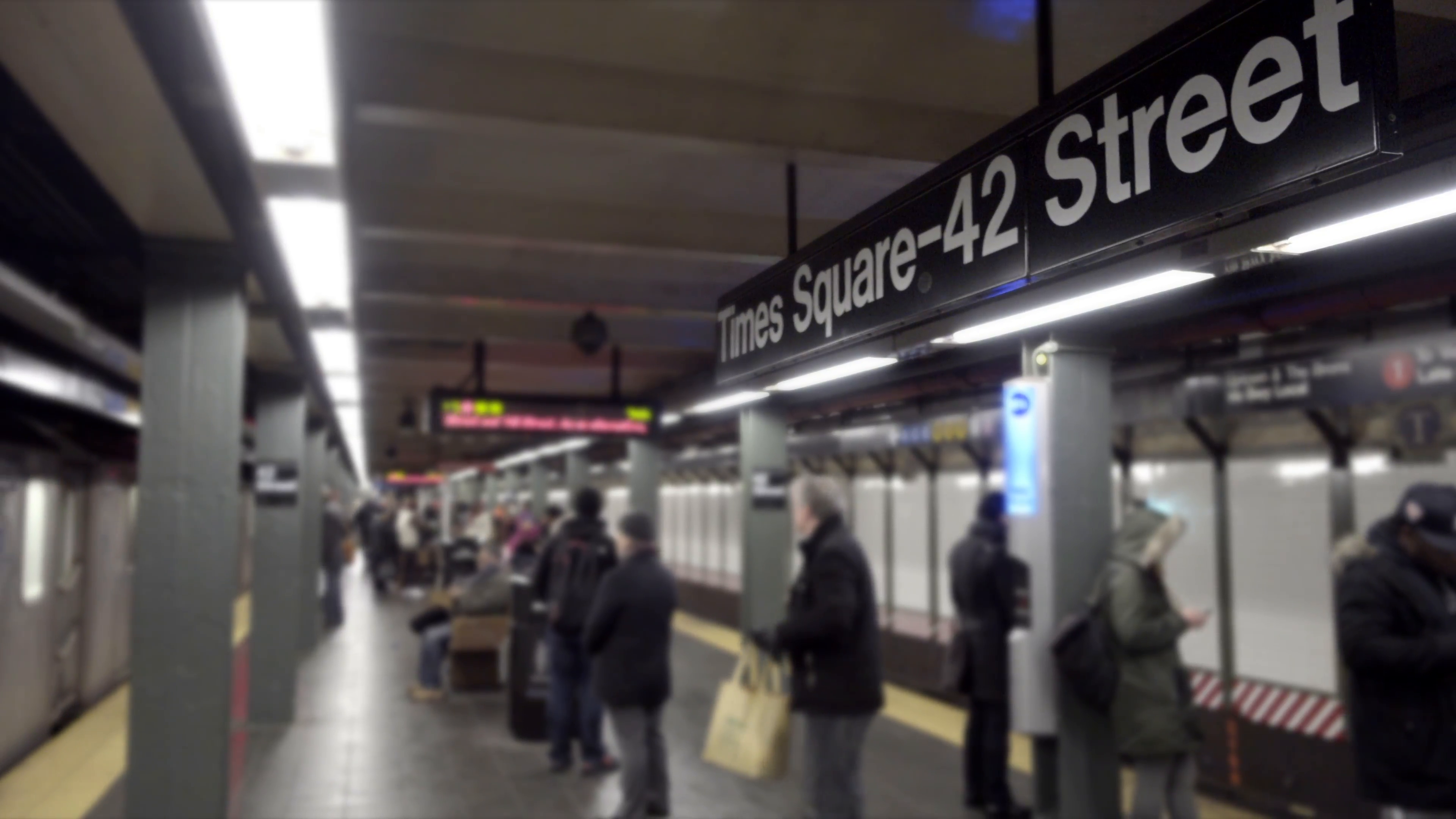 subway train leaving platform with Times Square 42nd Street station ...
