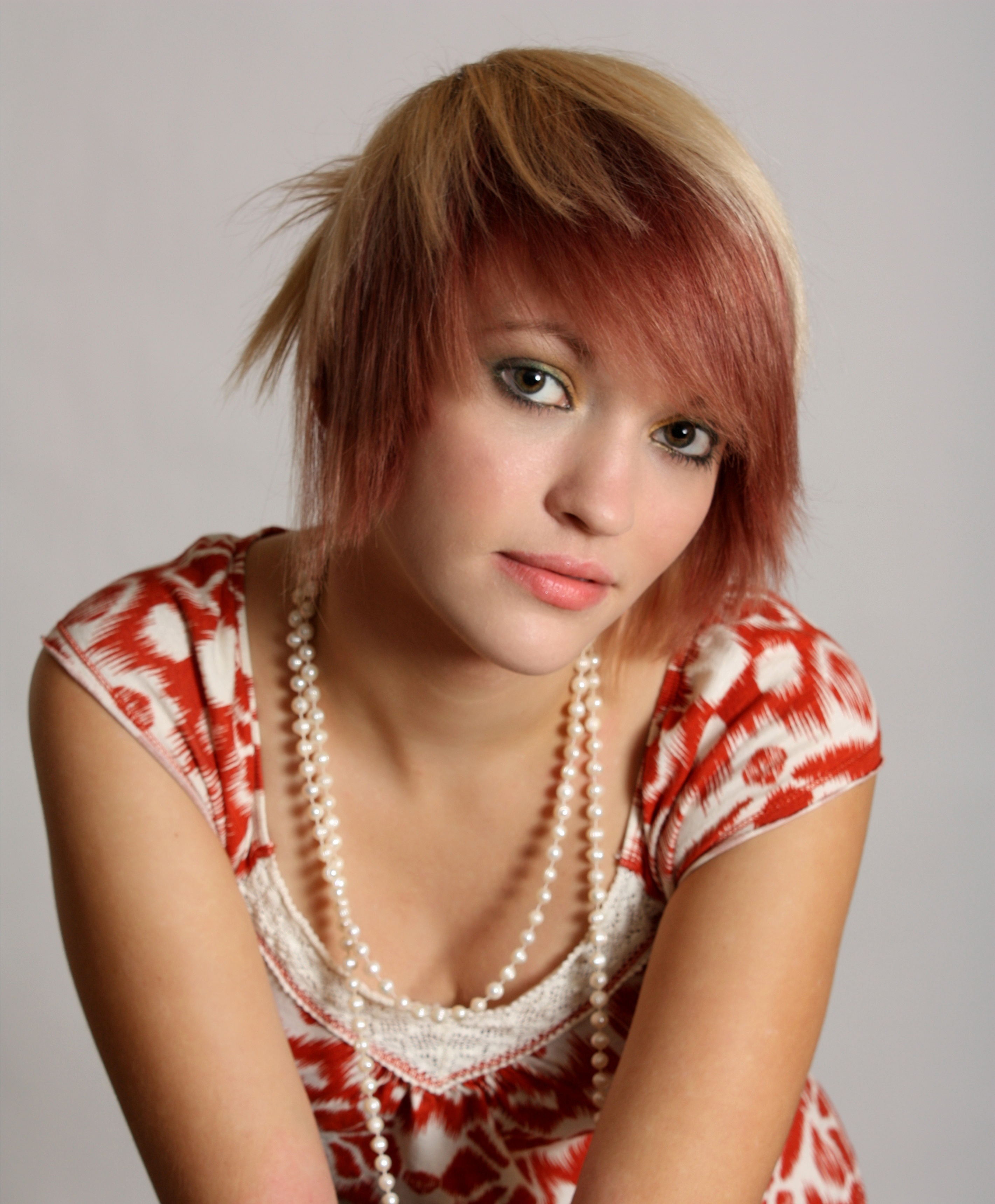 A beautiful young woman wearing pearls photo