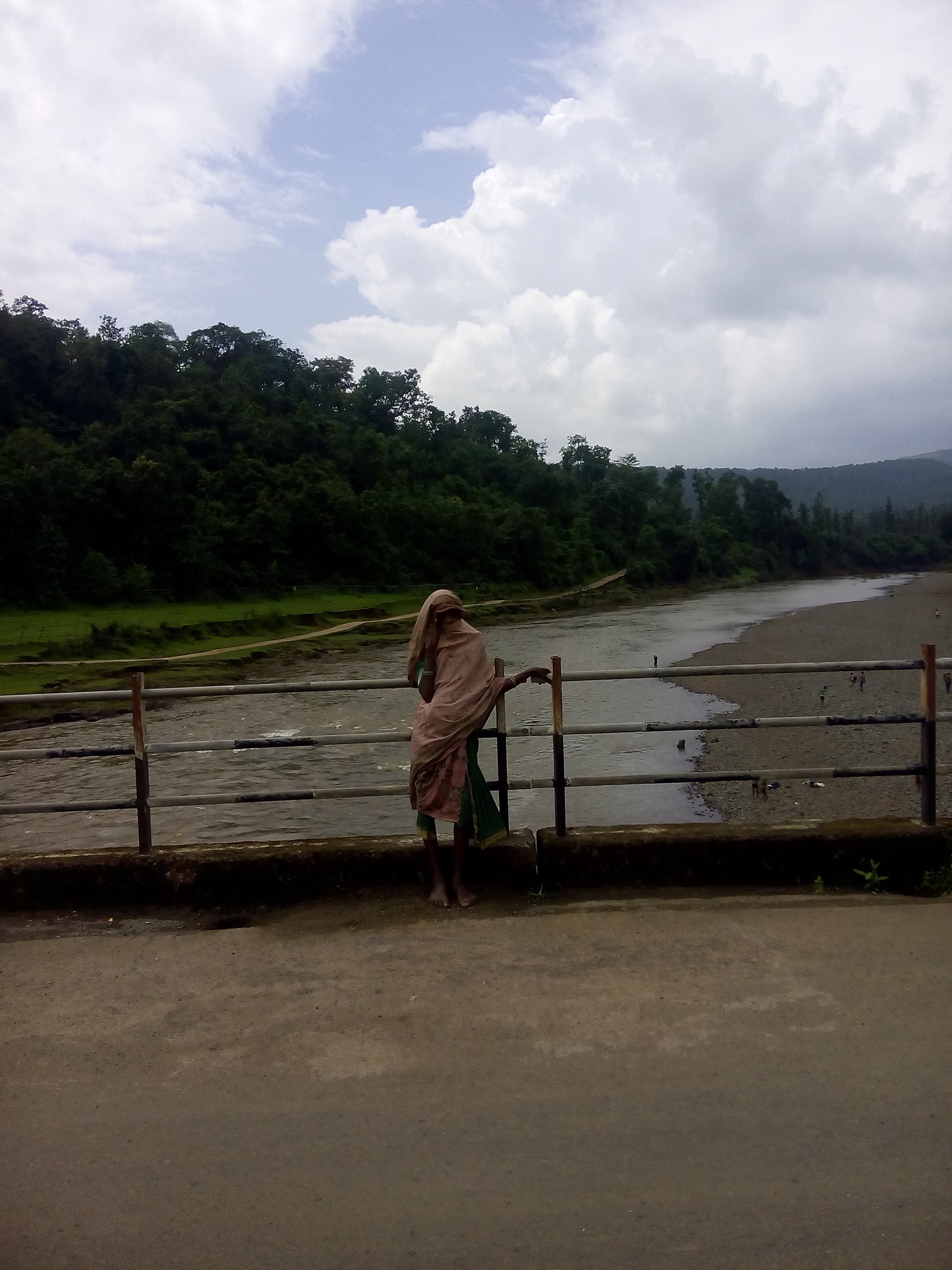 A rural indian women on small bridge photo