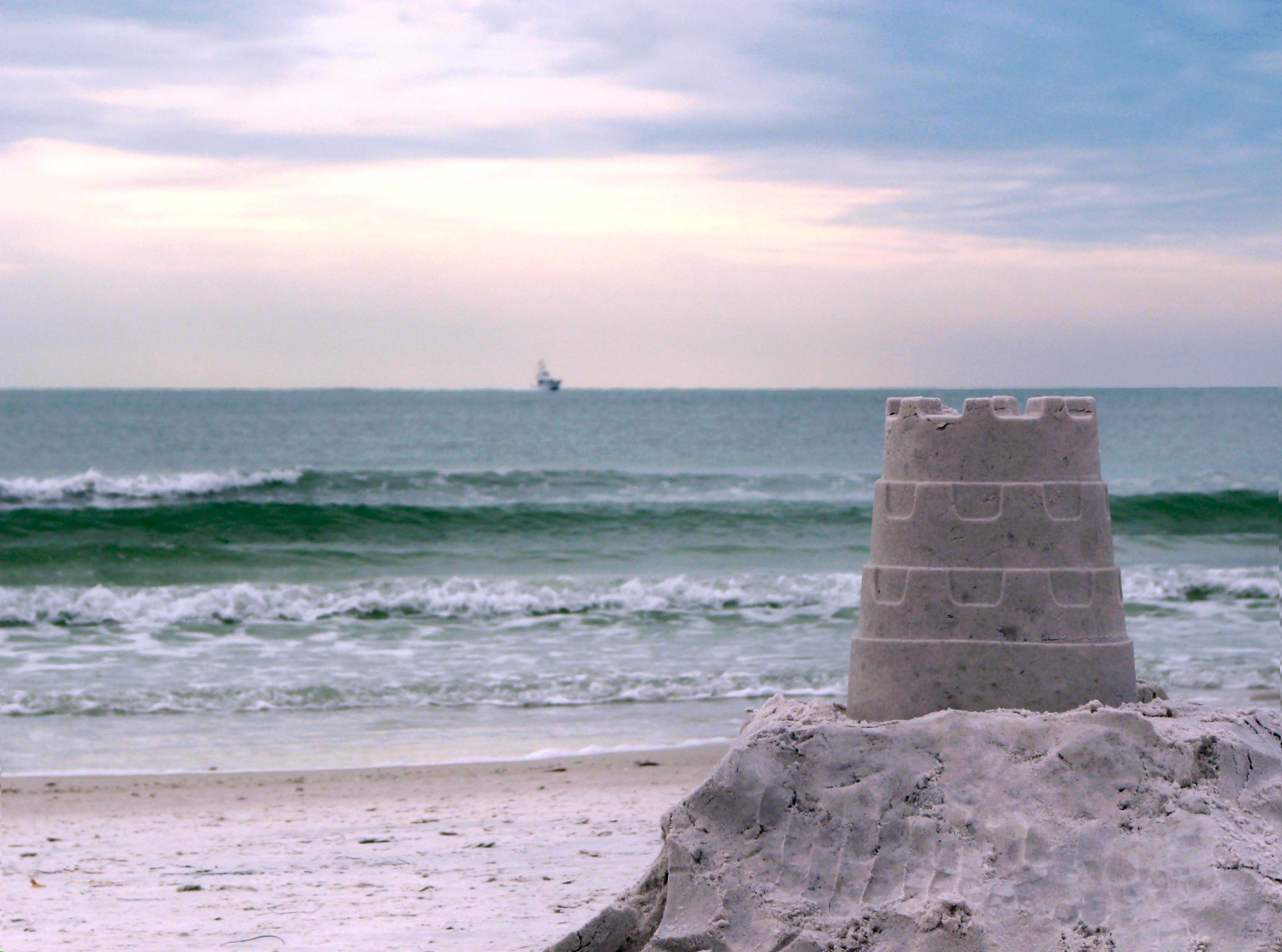 A sandcastle overlooking the ocean photo