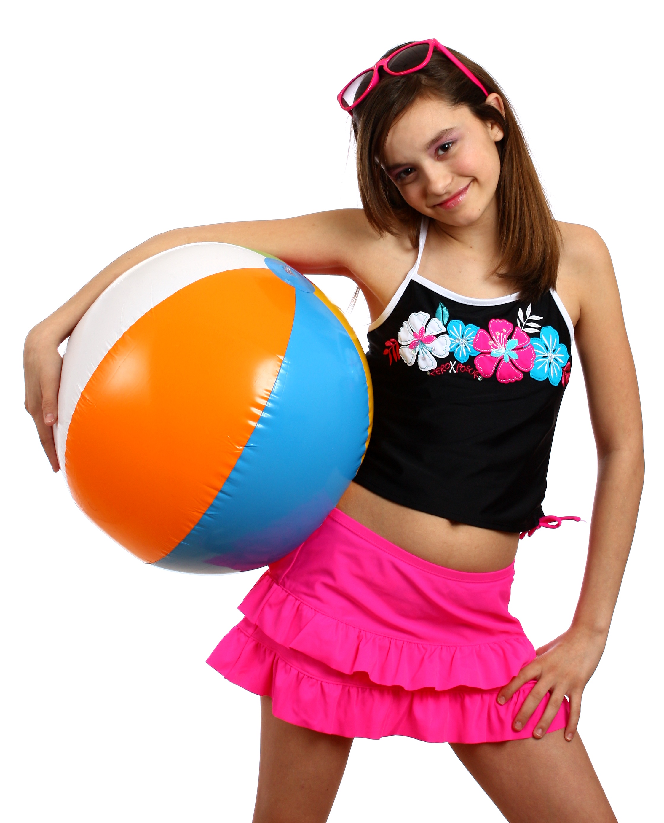 A young girl posing with a beach ball photo