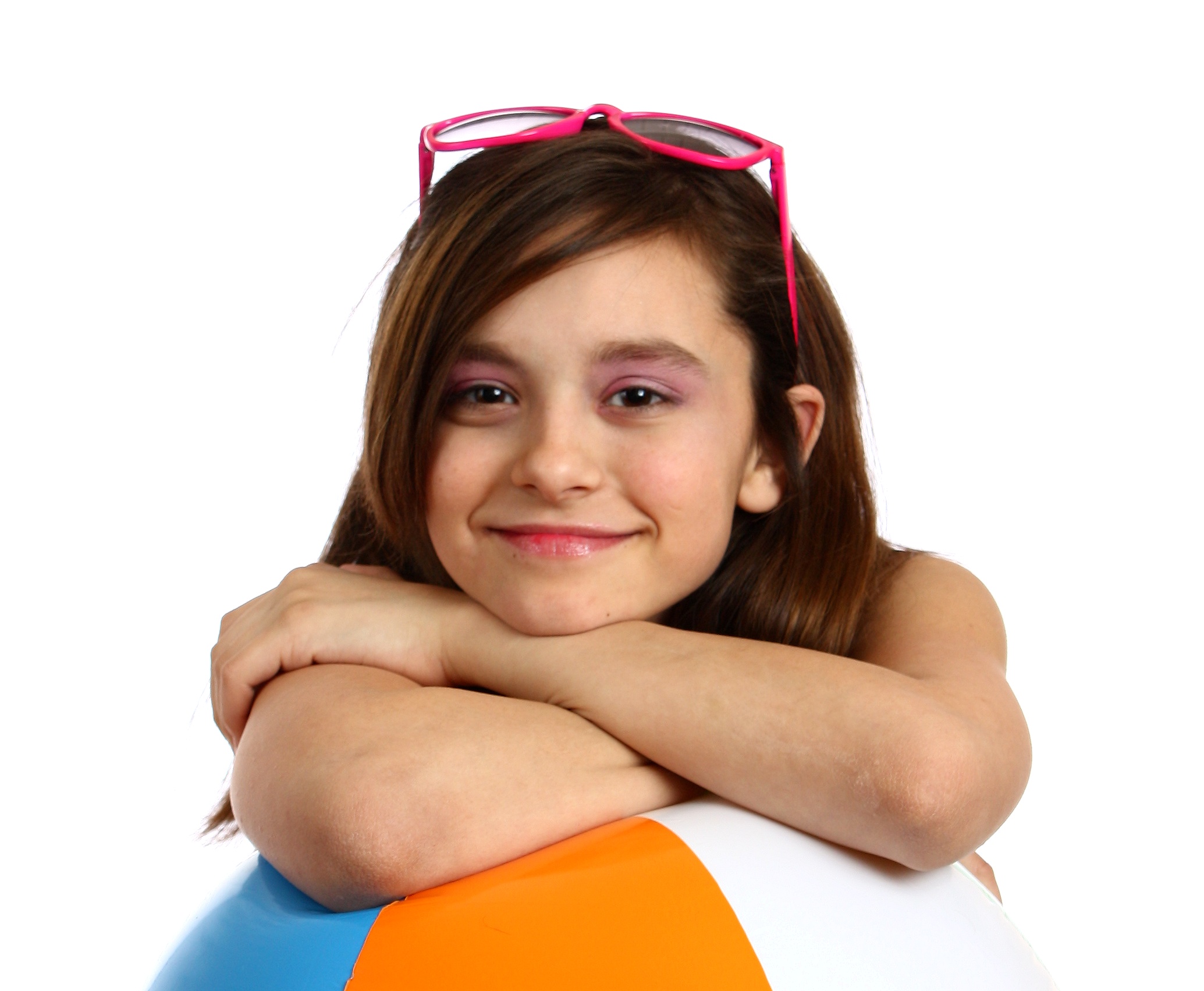 A young girl posing with a beach ball photo