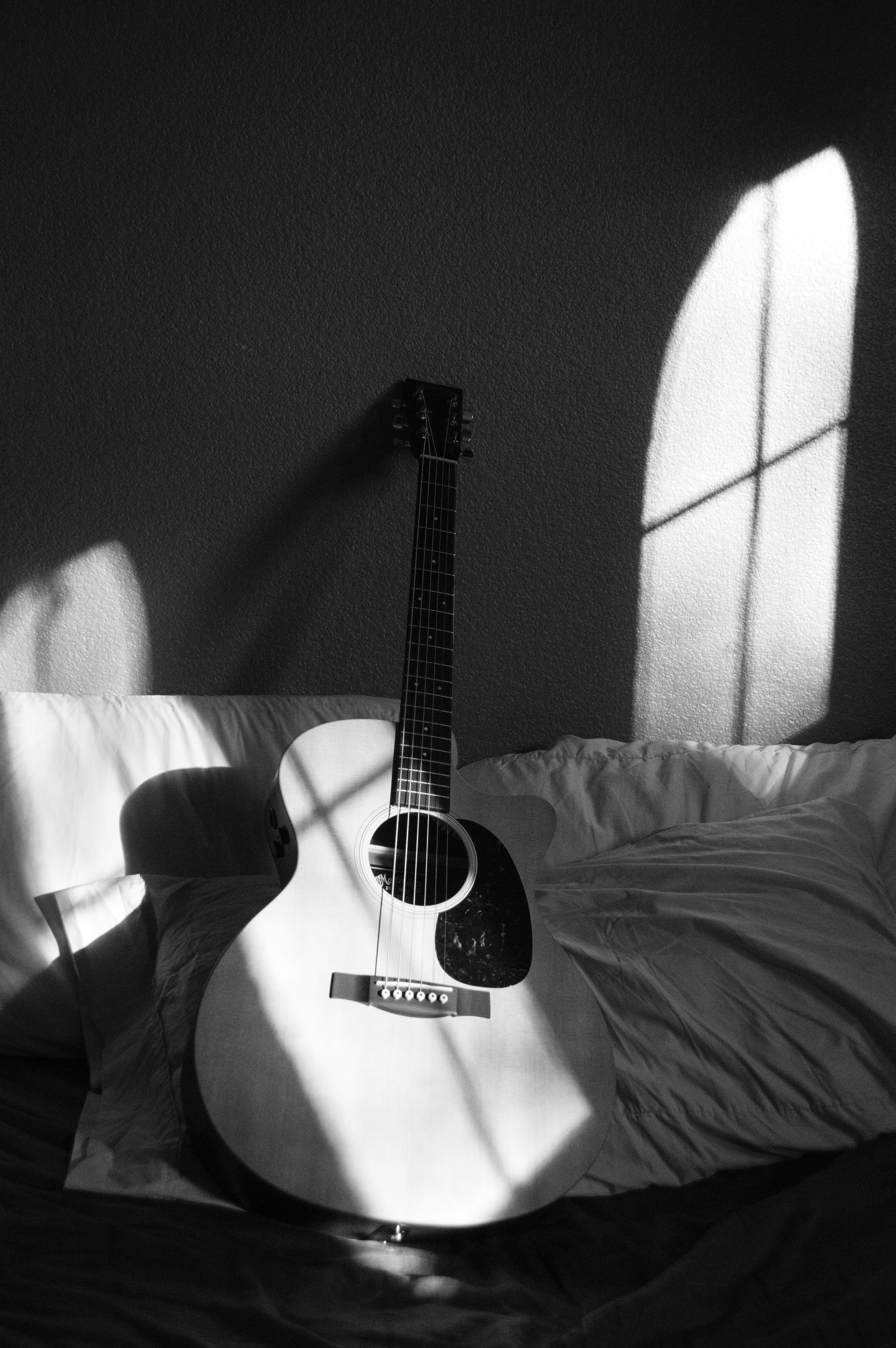 White Acoustic Guitar on Grey and White Textile · Free Stock Photo