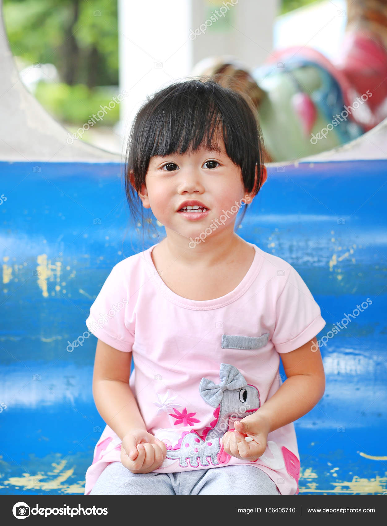Happy adorable kid girl smiling on a carriage in a carousel — Stock ...