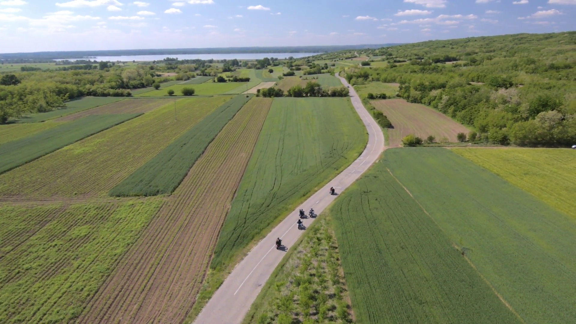 Aerial view on group of bikers riding on the rural area road ...