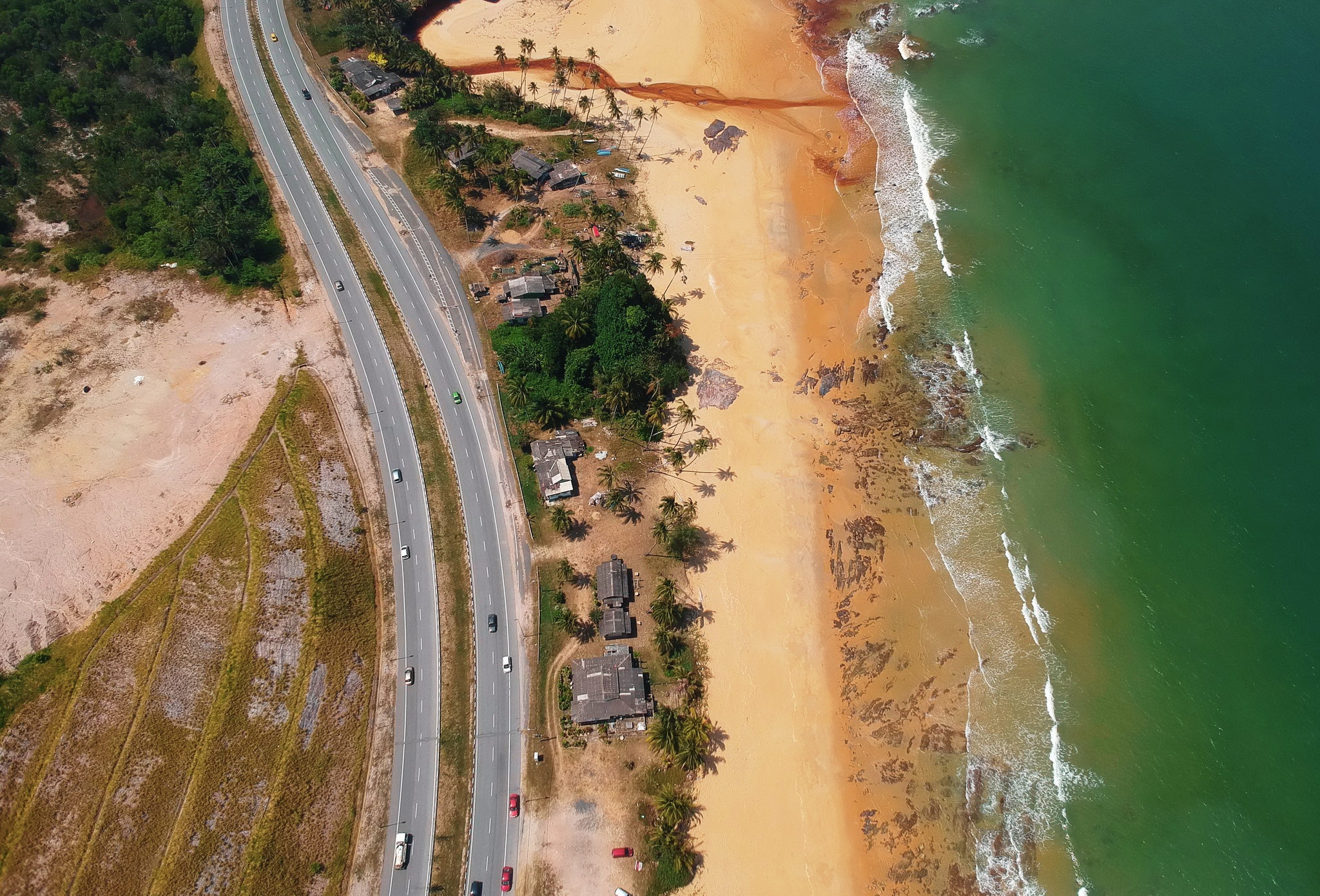 Aerial view of road beside the seashore photo