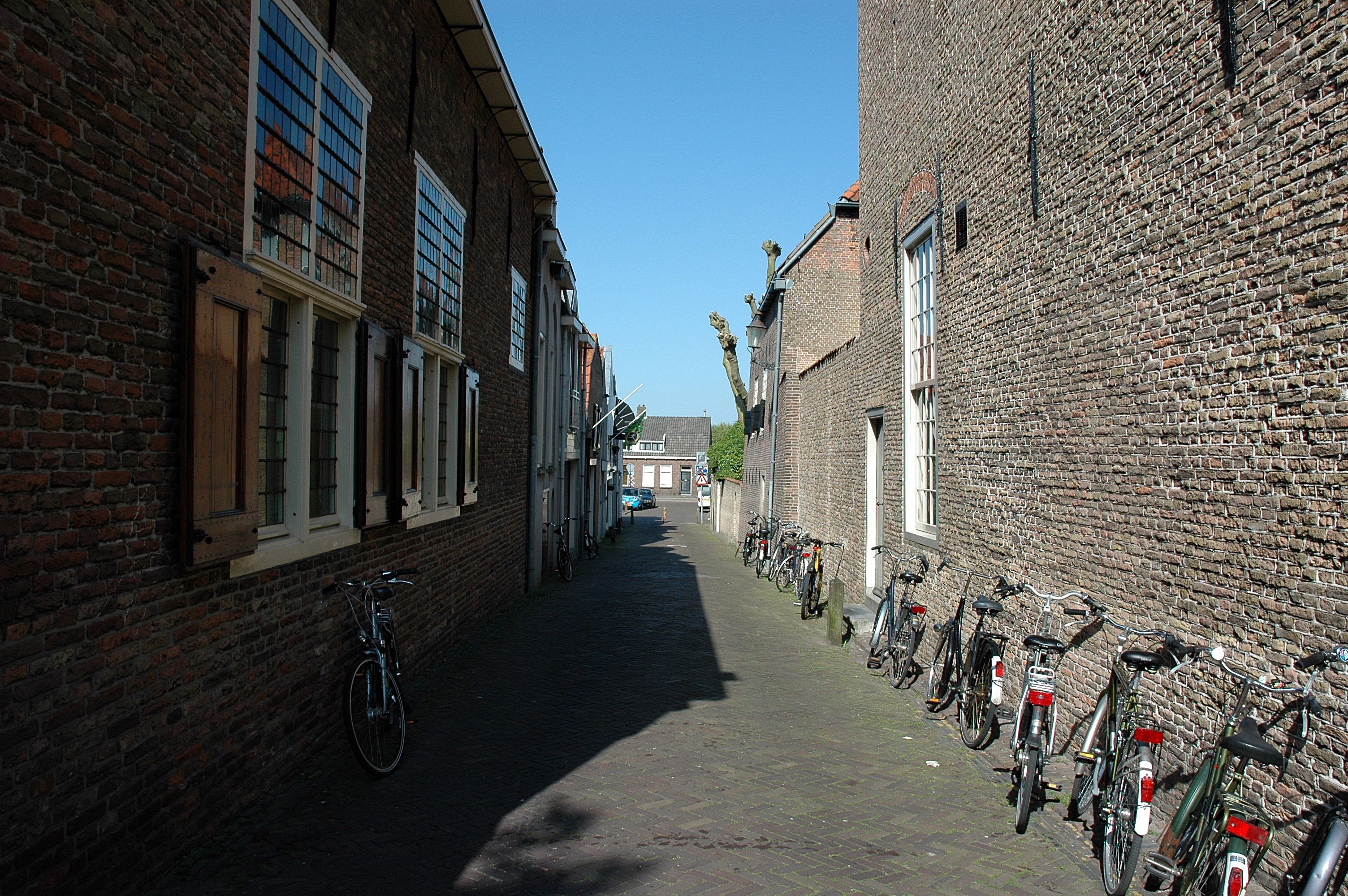 Alley with parked bicycles photo