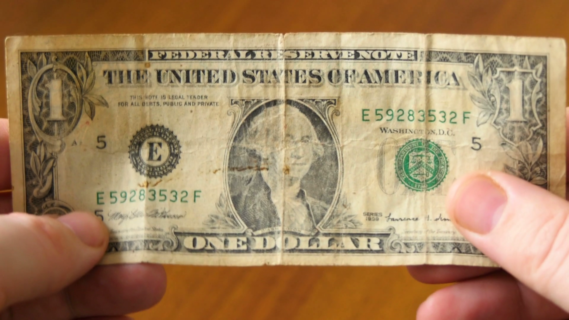 One american dollar banknote in male hands. Old crumpled buck bill ...