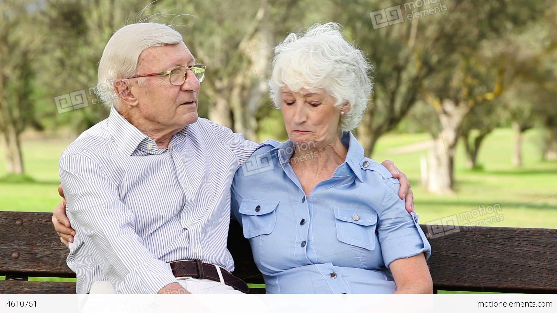 Old Couple On A Bench Talking Stock video footage | 4610761
