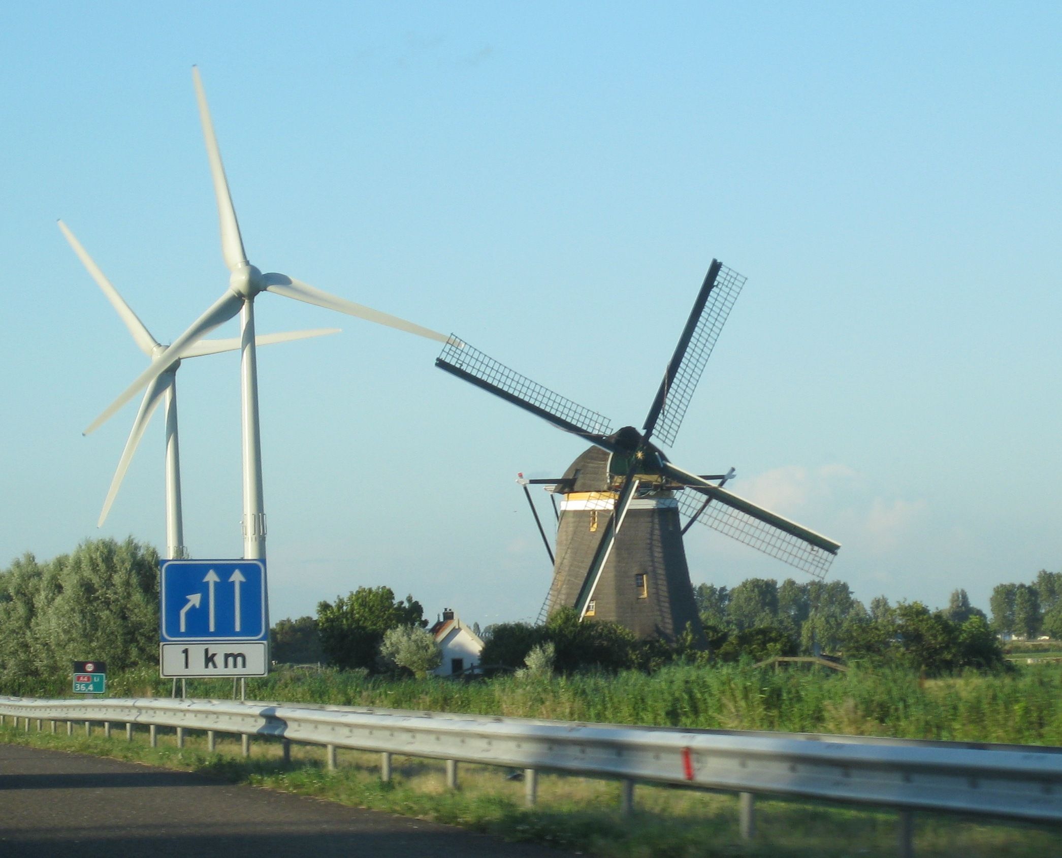 Modern and ancient windmill, heading north on the A4 highway, just ...