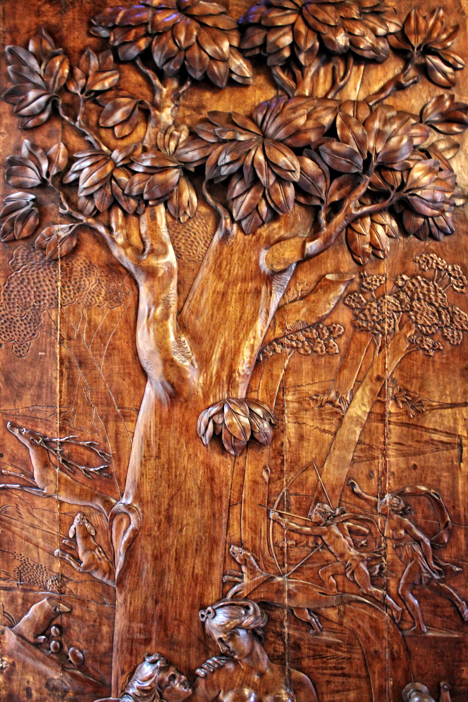 Antique carved wood door - hunting scene photo