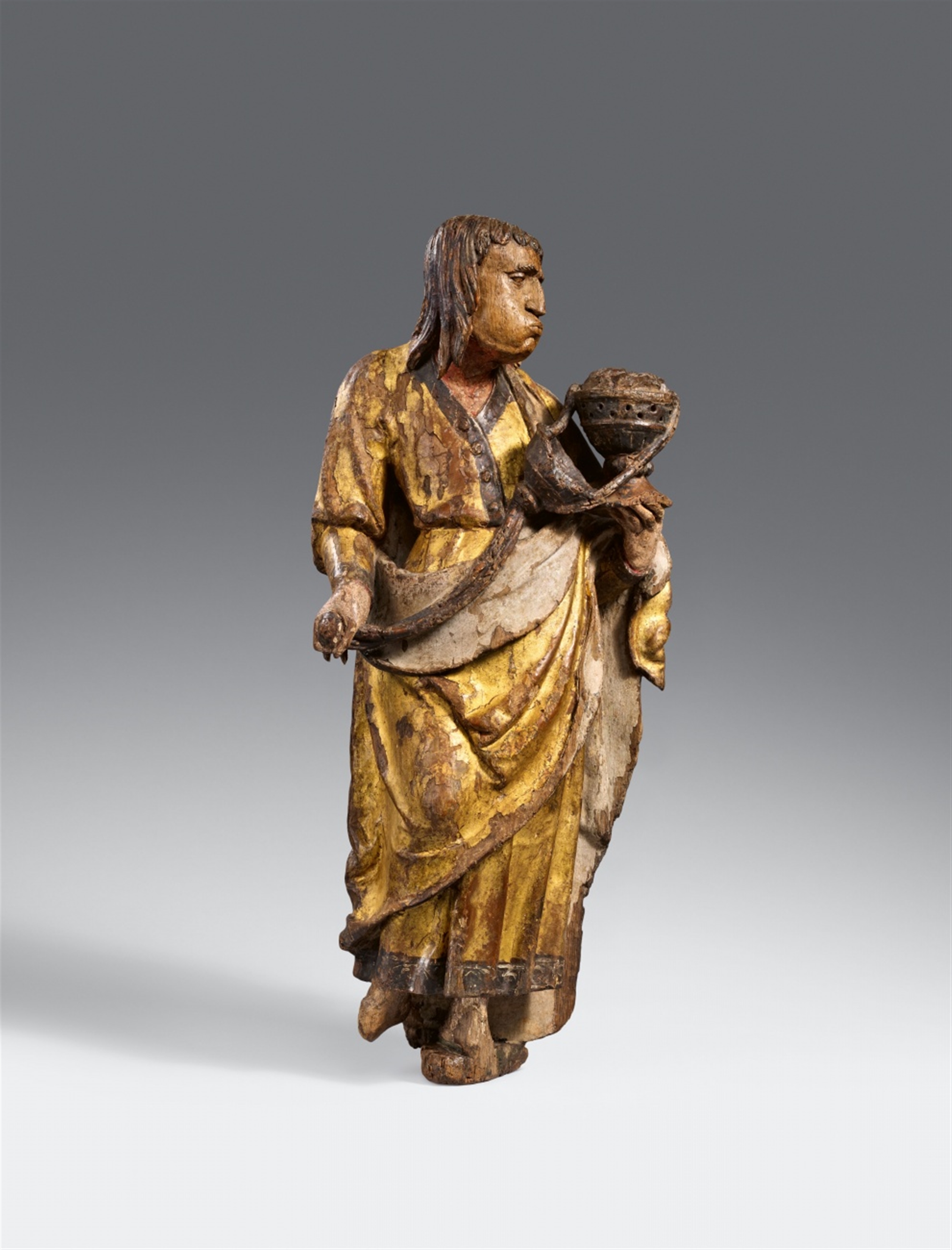 An Antwerp carved oak figure of an Apostle with an incense burner ...