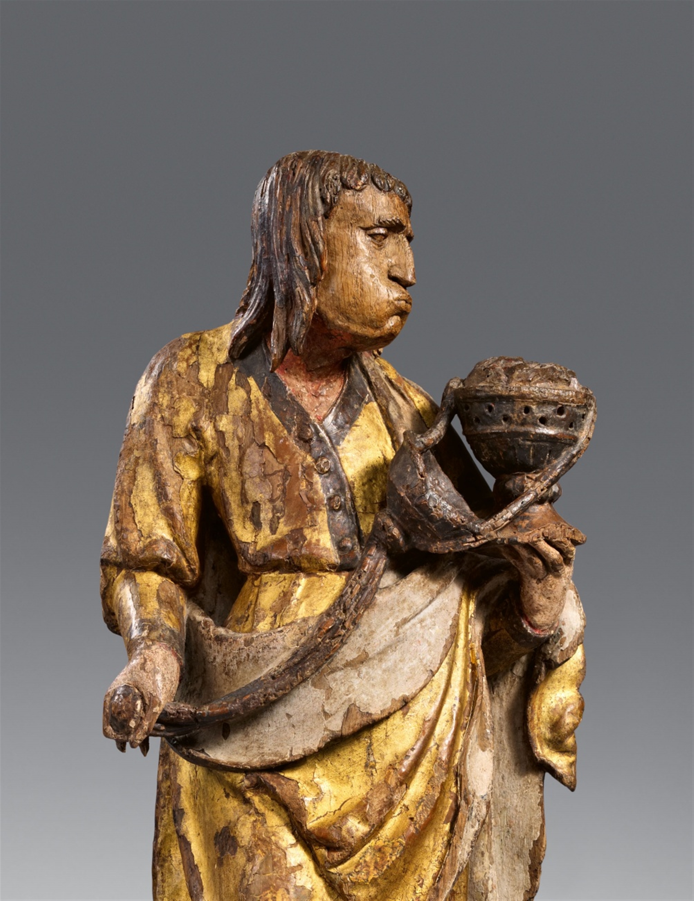 An Antwerp carved oak figure of an Apostle with an incense burner ...