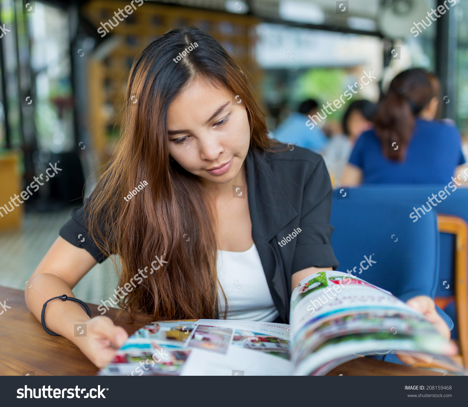 Young Asian Woman Reading Magazine Restaurant Stock Photo (Royalty ...