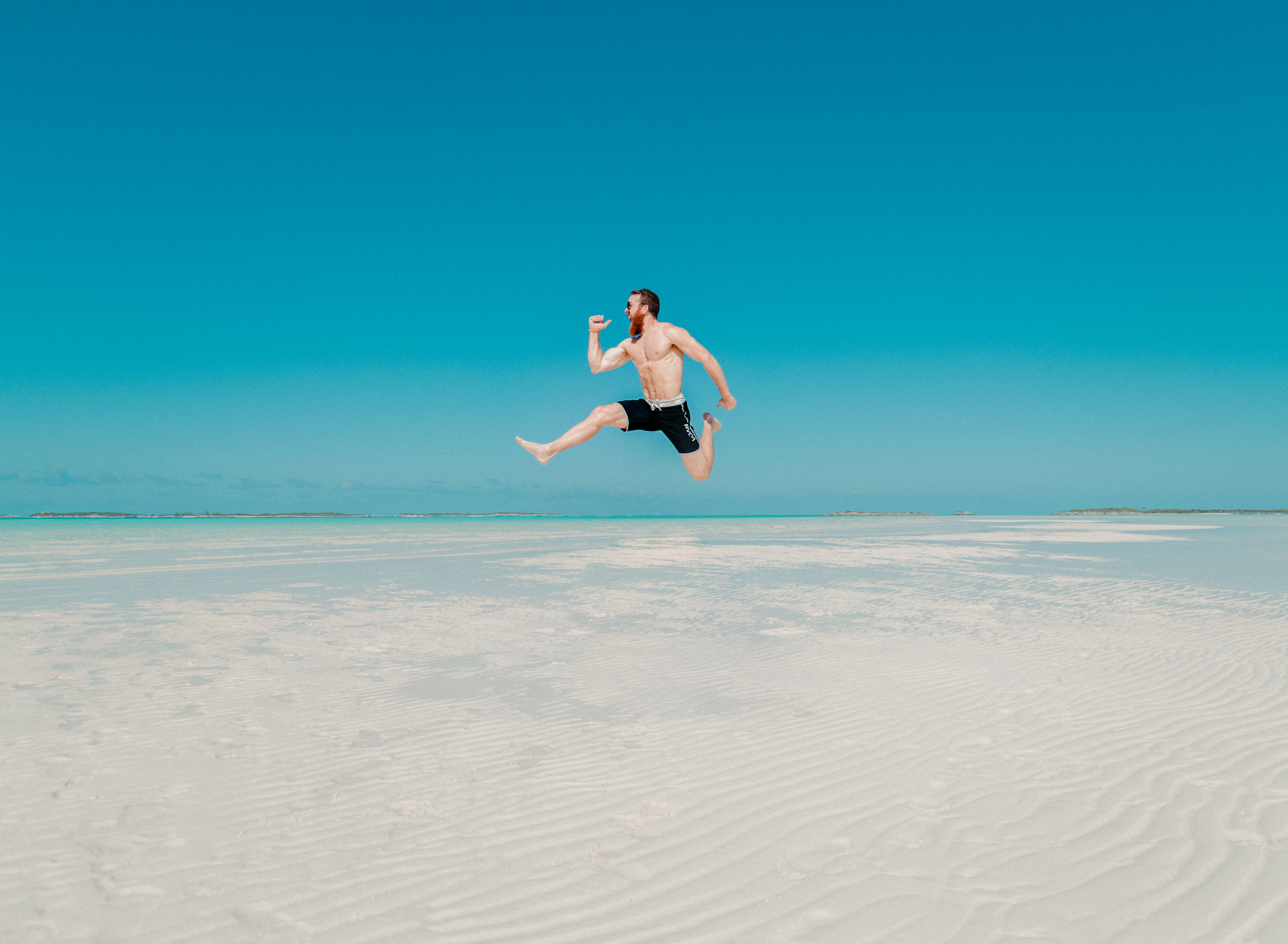 Man jumping at the beach on the sand on bright summer day - Enjoy ...
