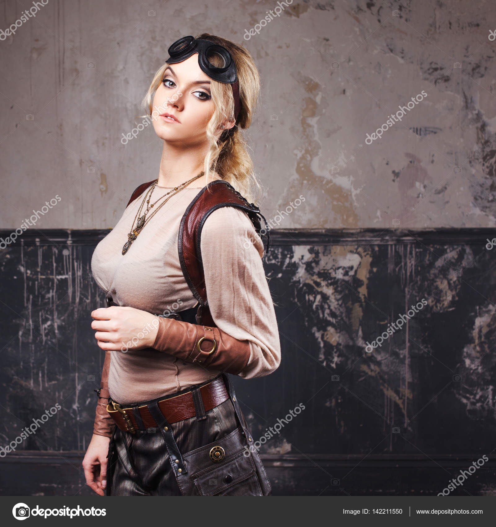 Portrait of a beautiful steampunk woman in Aviator glasses over grey ...