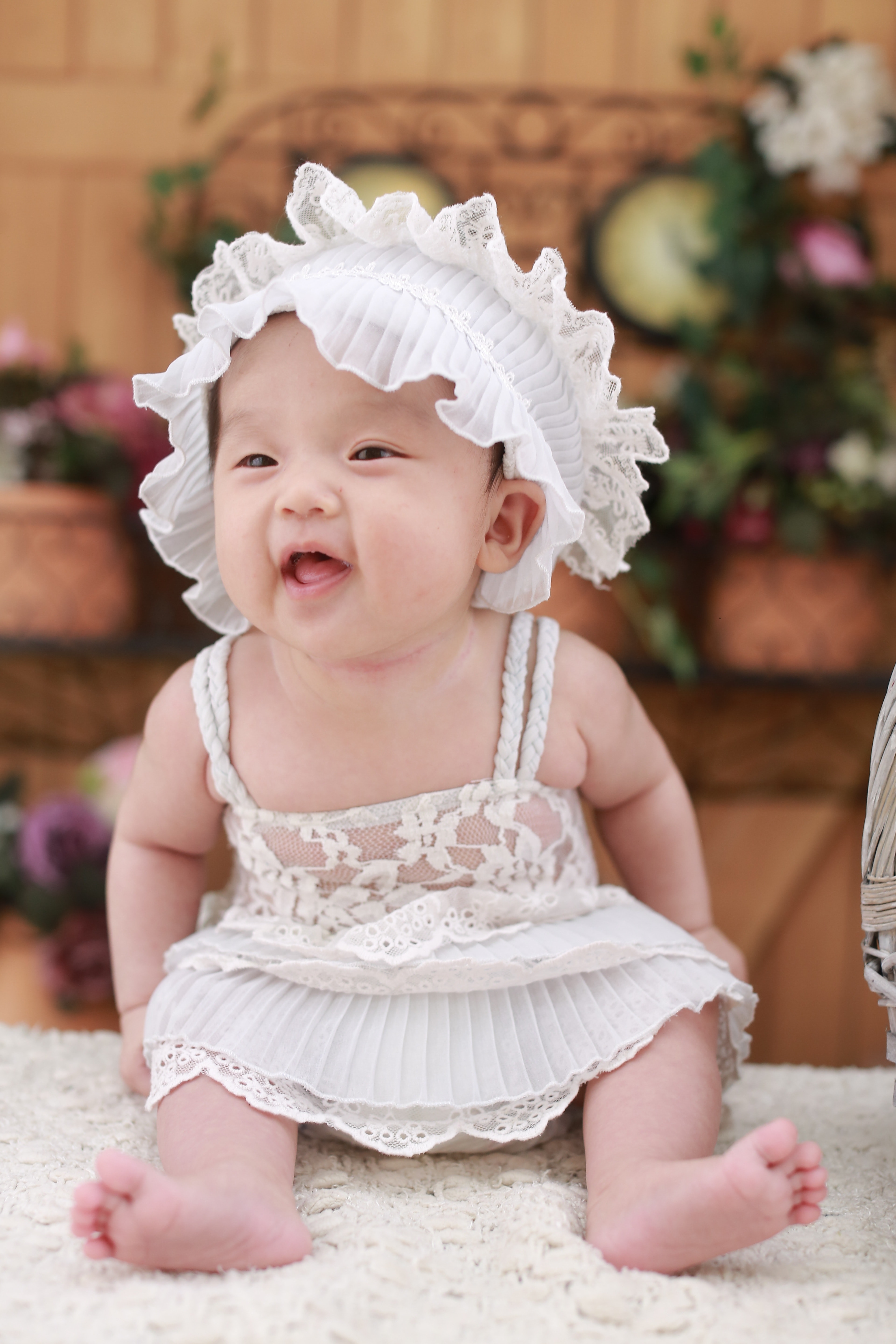 Baby in white dress with white headdress photo