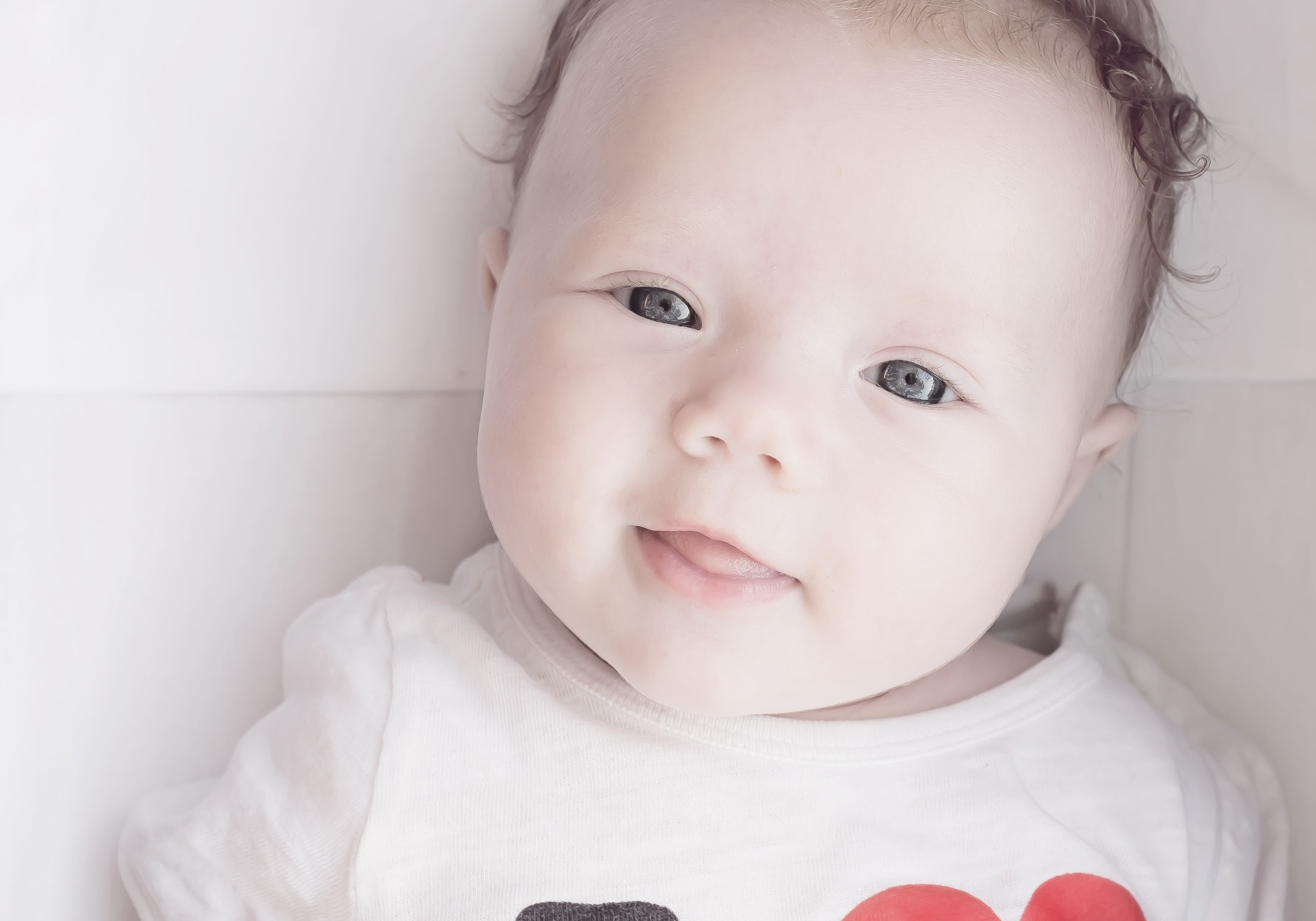 Baby wearing white red and black t shirt photo