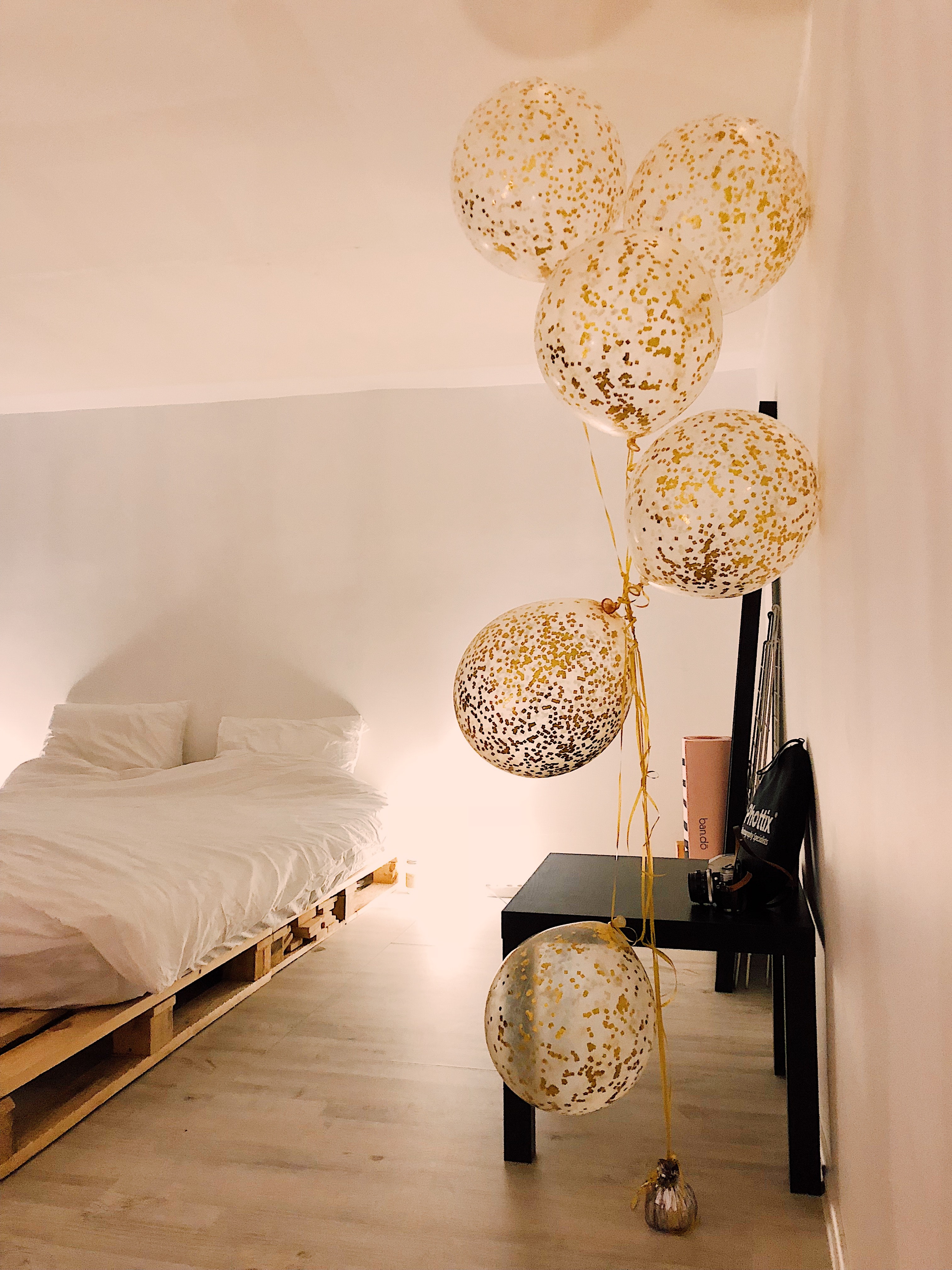 Balloons near white bedspread set photo