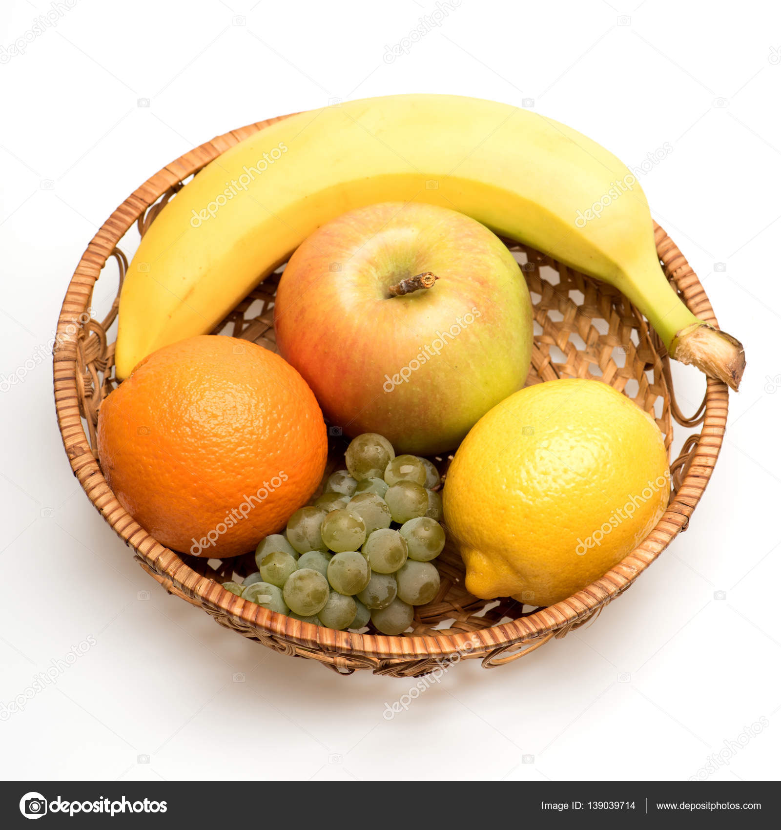 banana, lemon, apple, grapes and orange fruit in straw basket ...