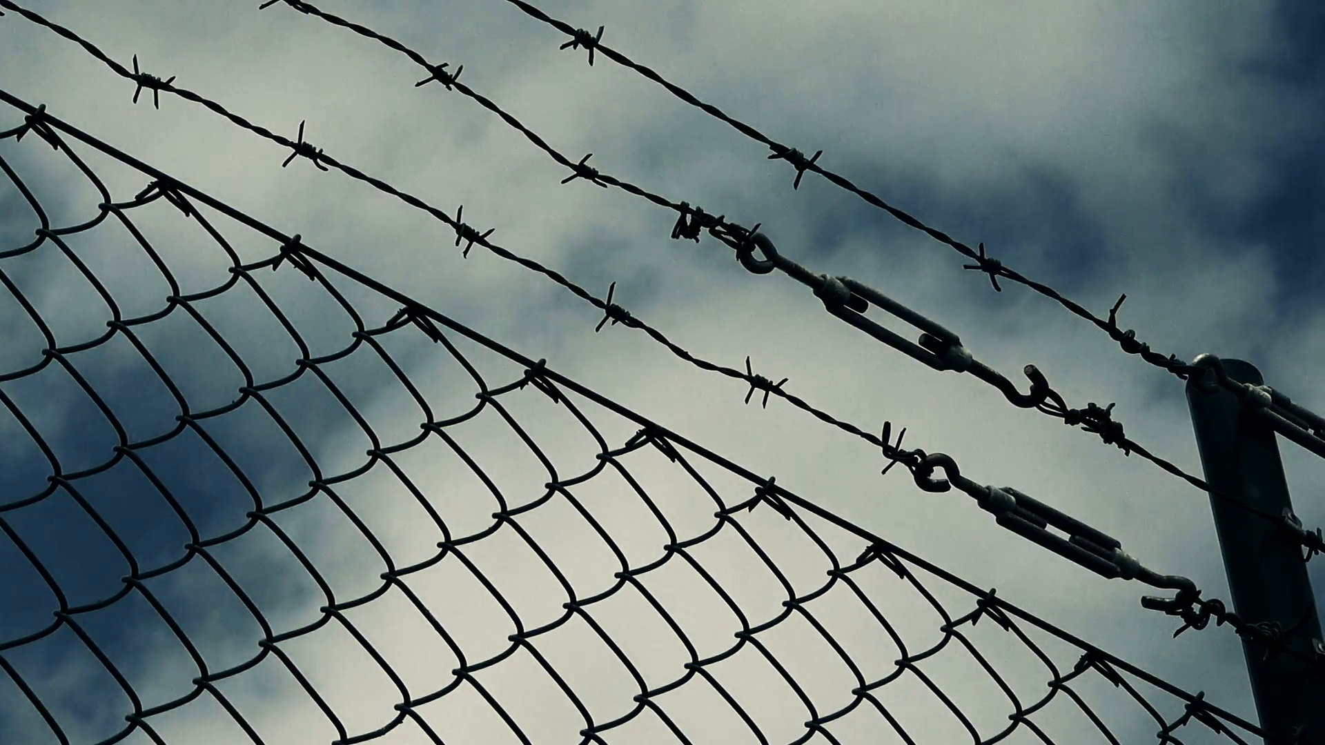 Barb wire fence and clouds, dreaming of freedom concept, time lapse ...