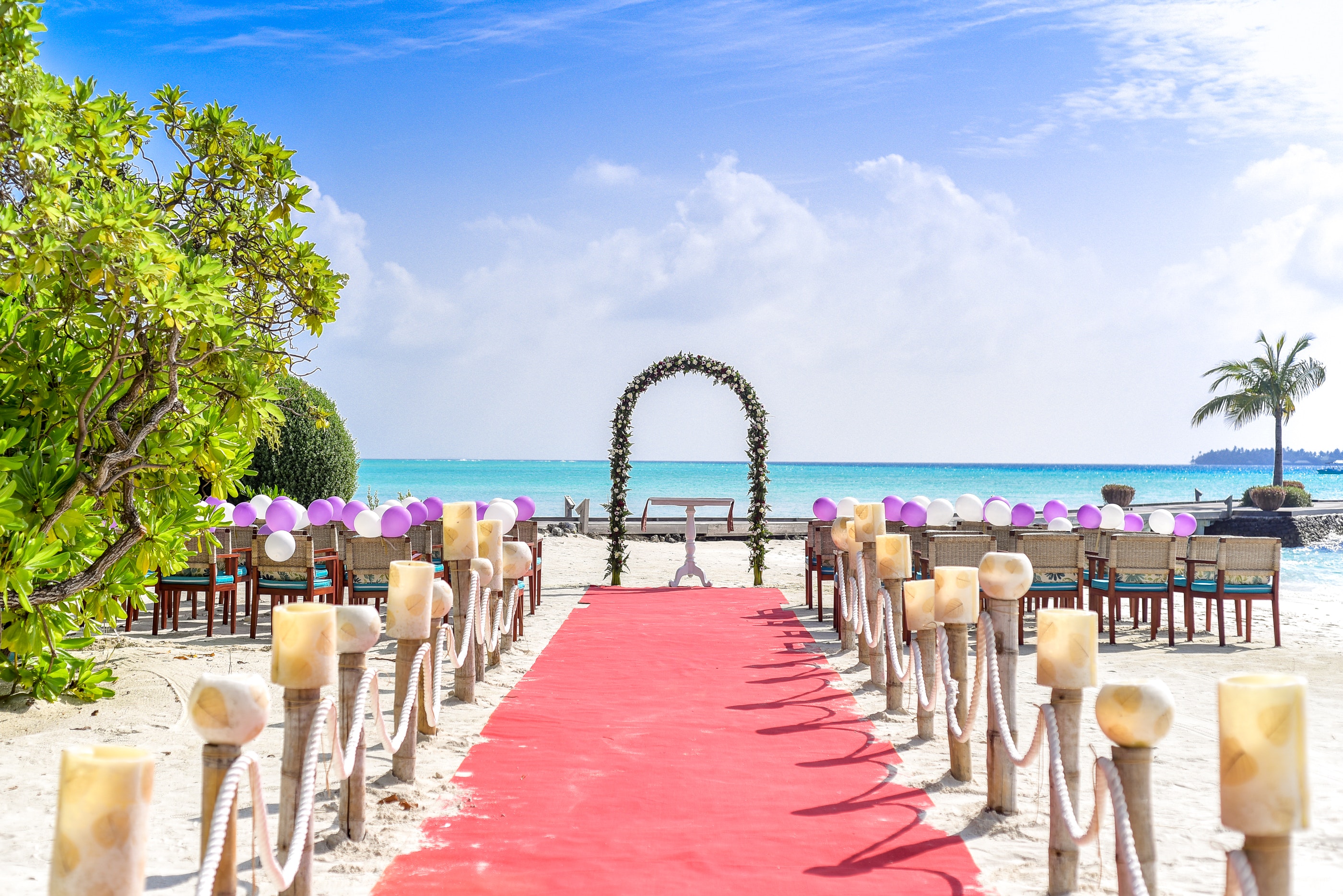 Beach wedding event under white clouds and clear sky during daytime photo