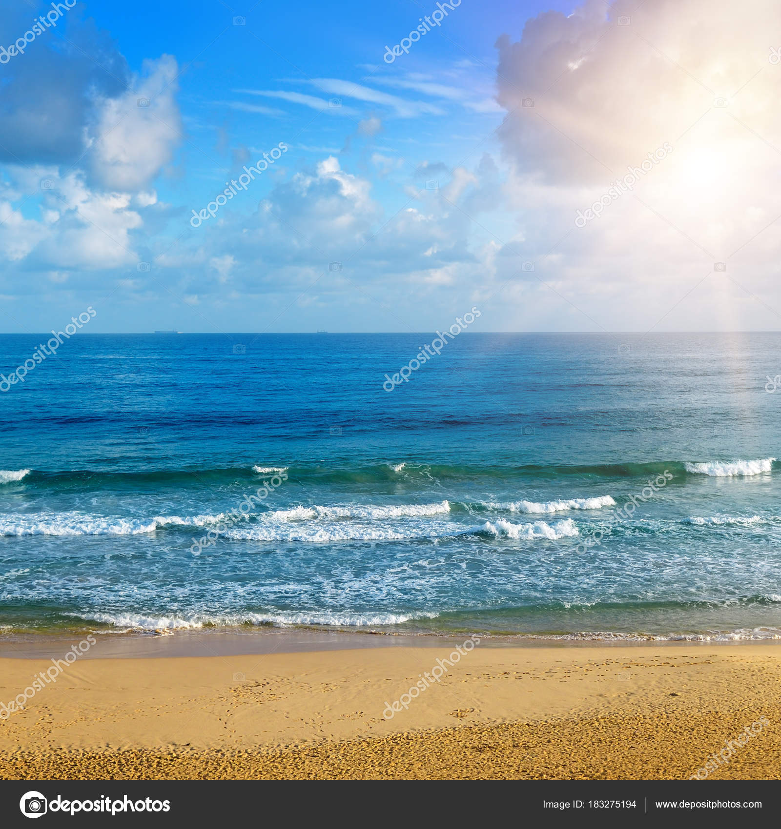 Beautiful seascape and sun on blue sky background. Extensive san ...