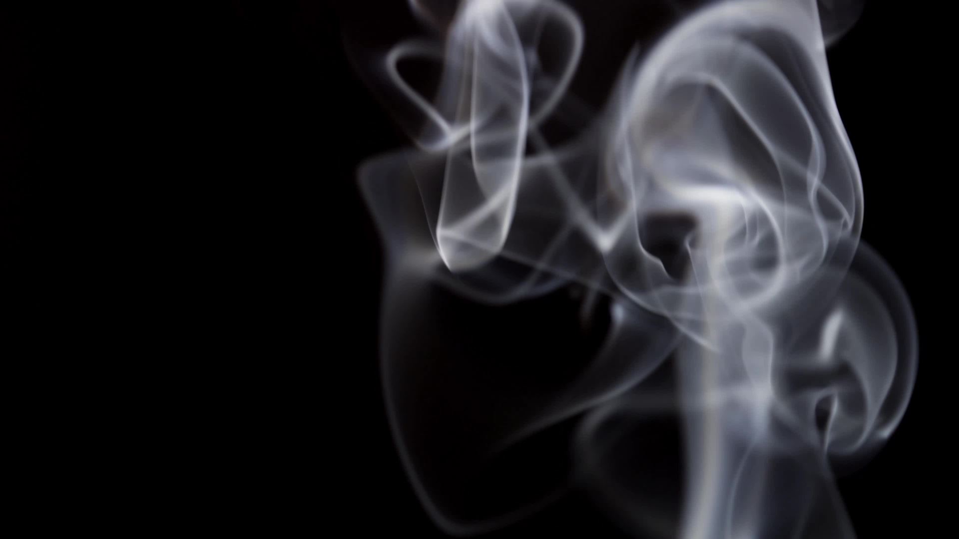 Beautiful smoke shapes moving in focused and blurred focus points in ...