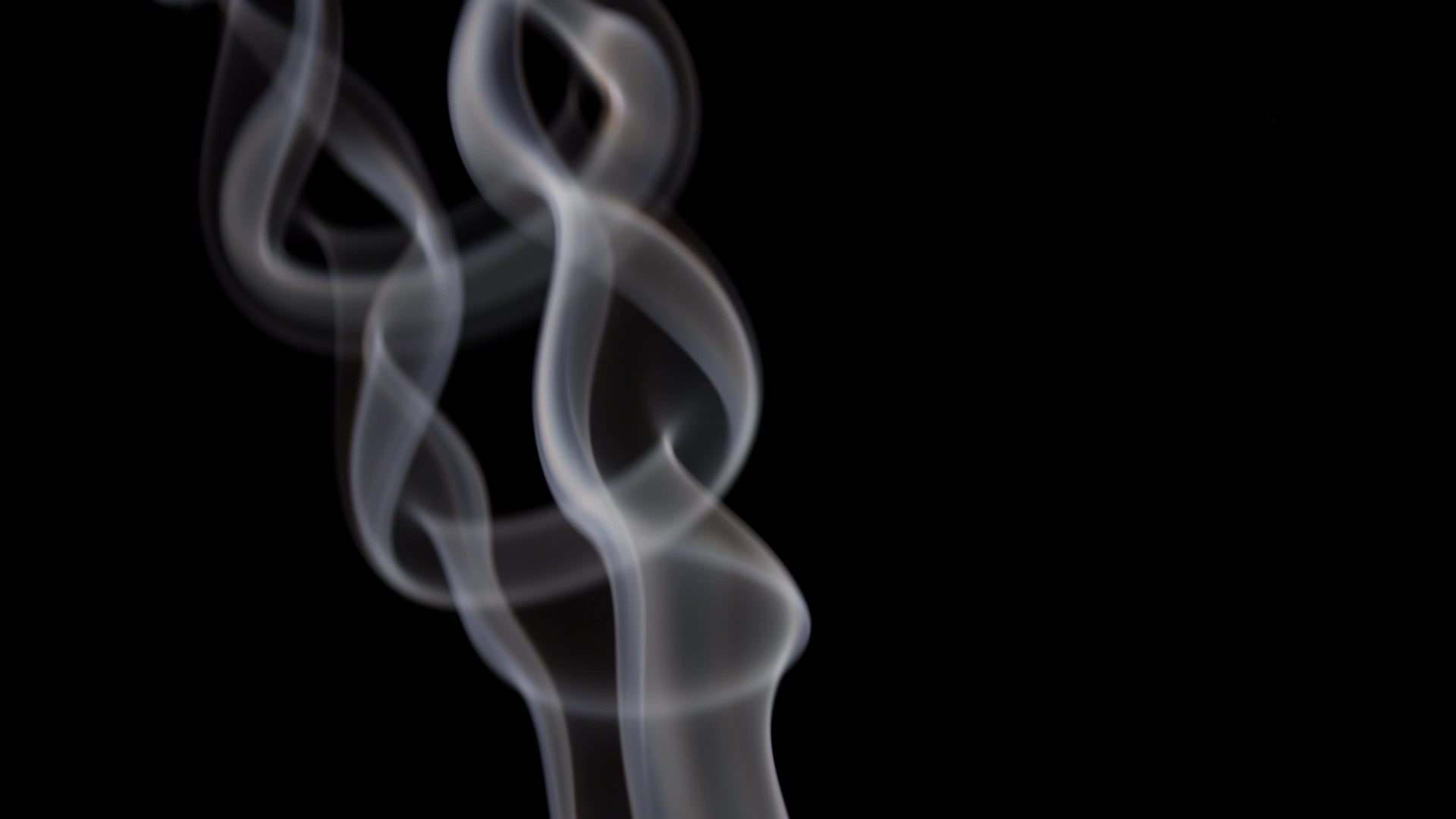 Beautiful smoke swirls with blurred and focused effect with dark ...