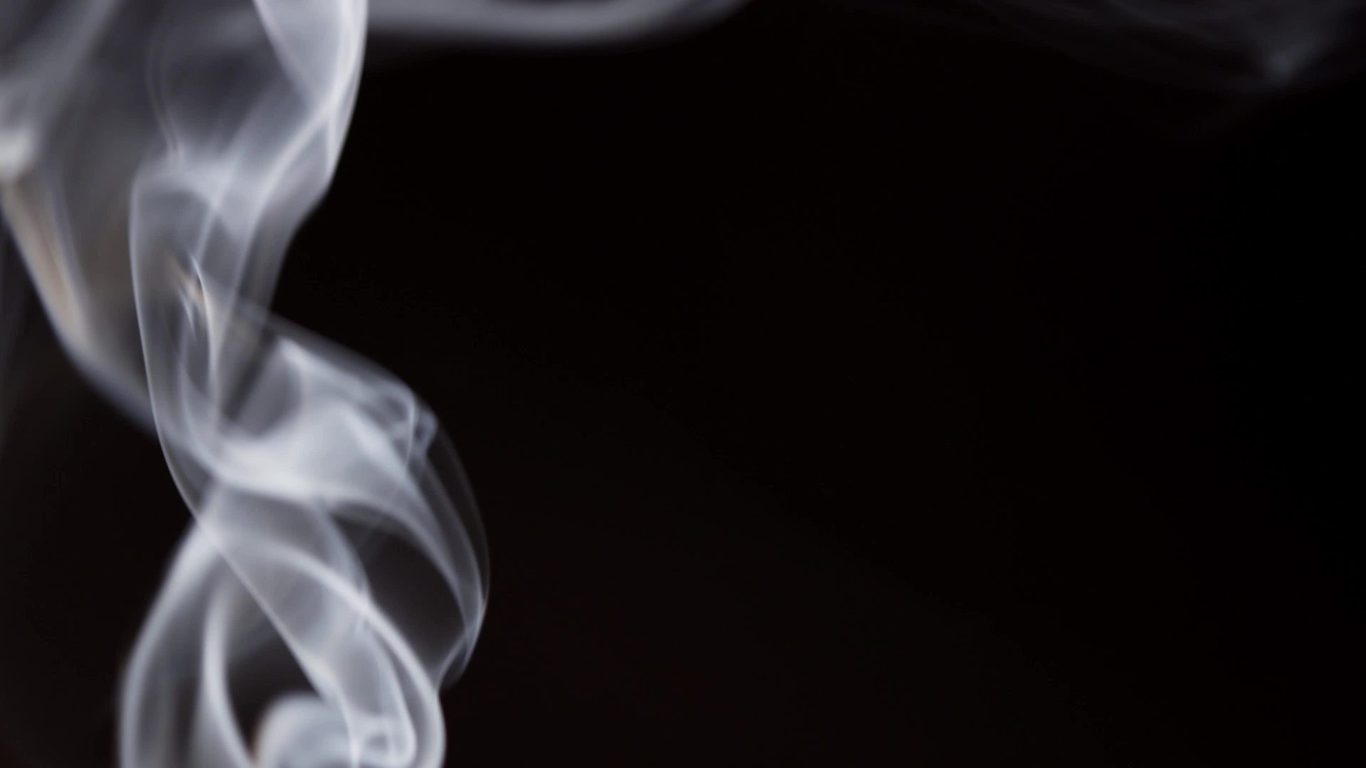 Close up of beautiful smoke shapes floating in darkness in 4K ...