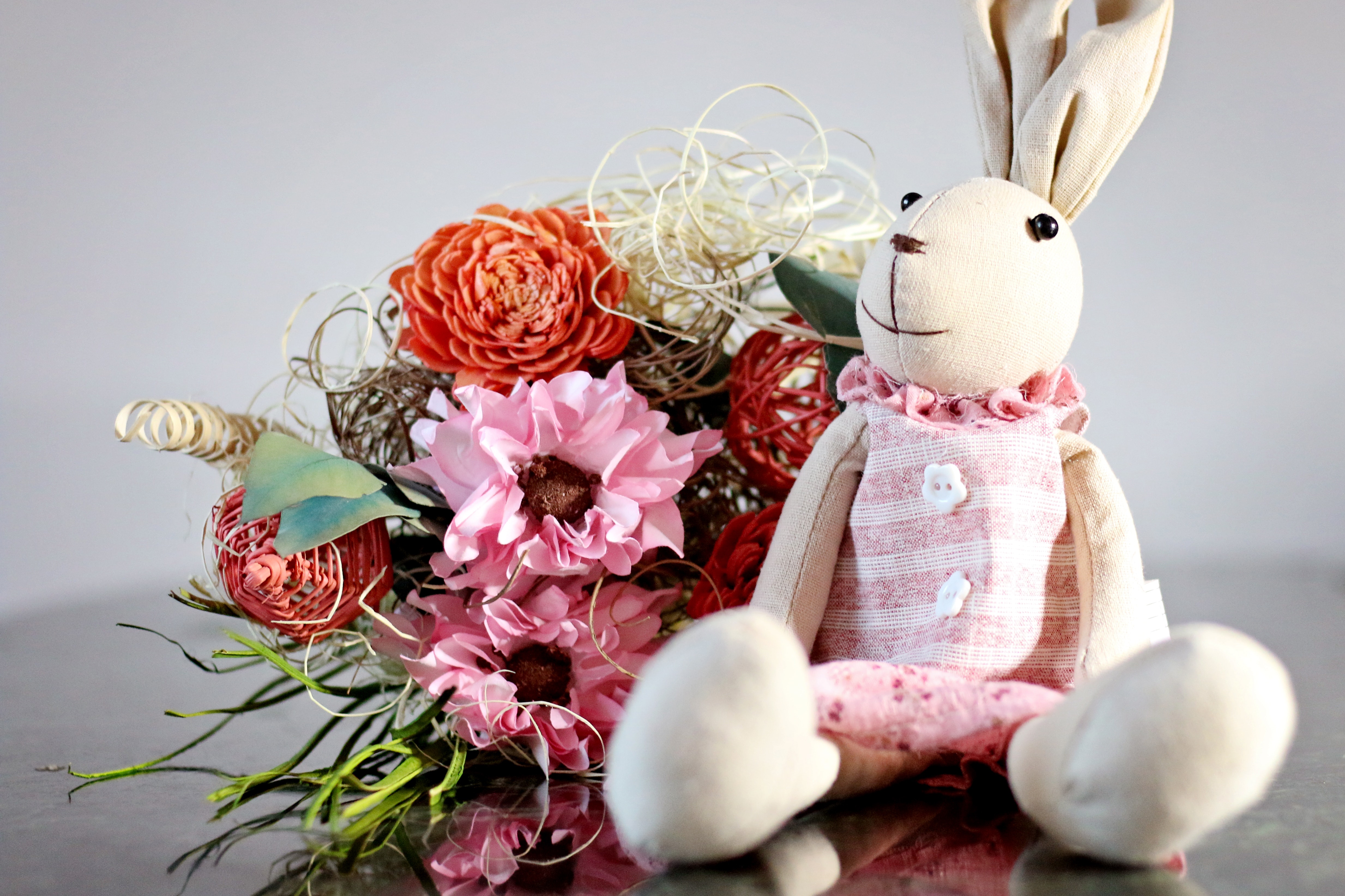 Beige bunny plush toy with pink cloth photo