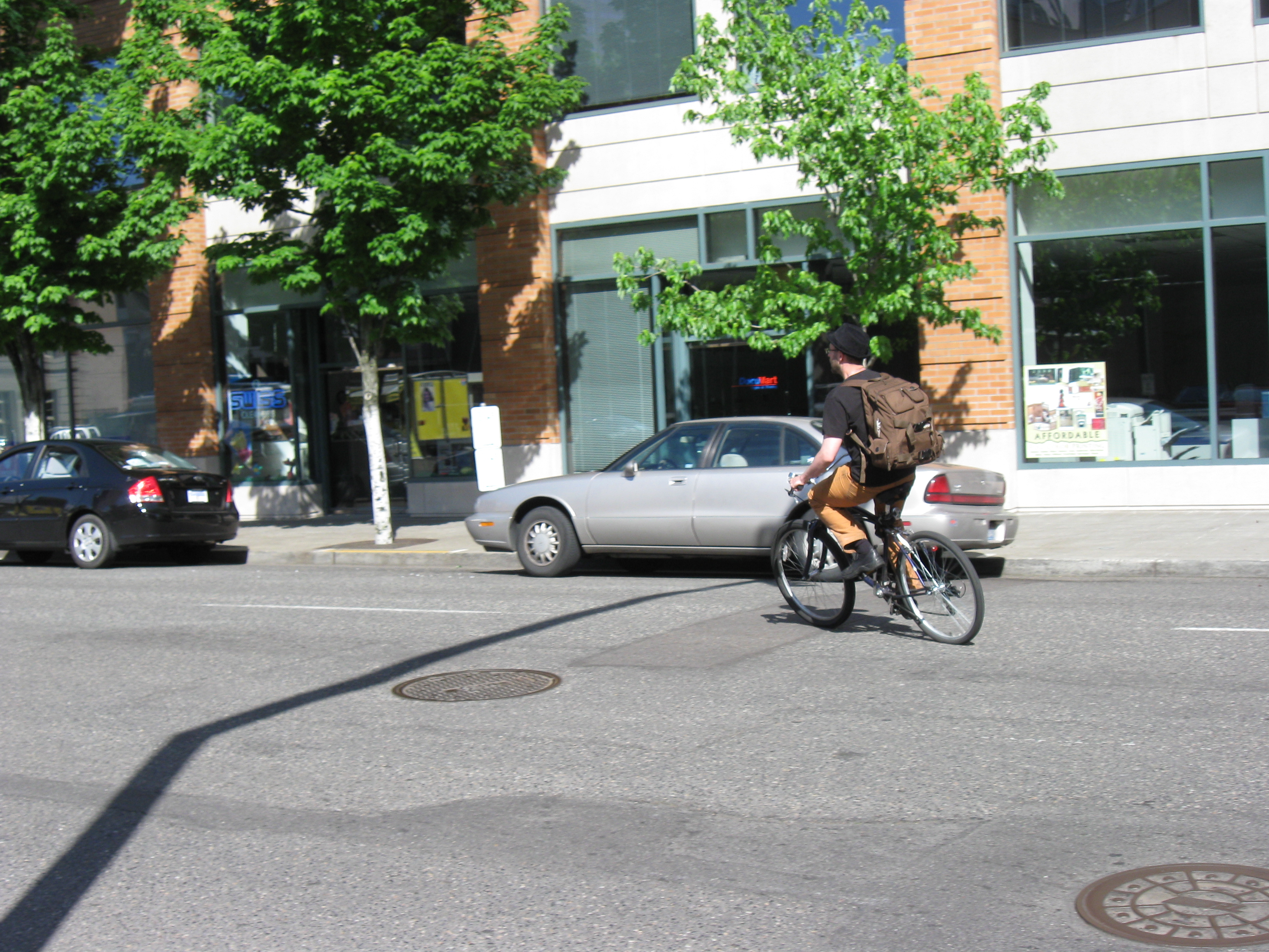 Bicyclist turning on street photo