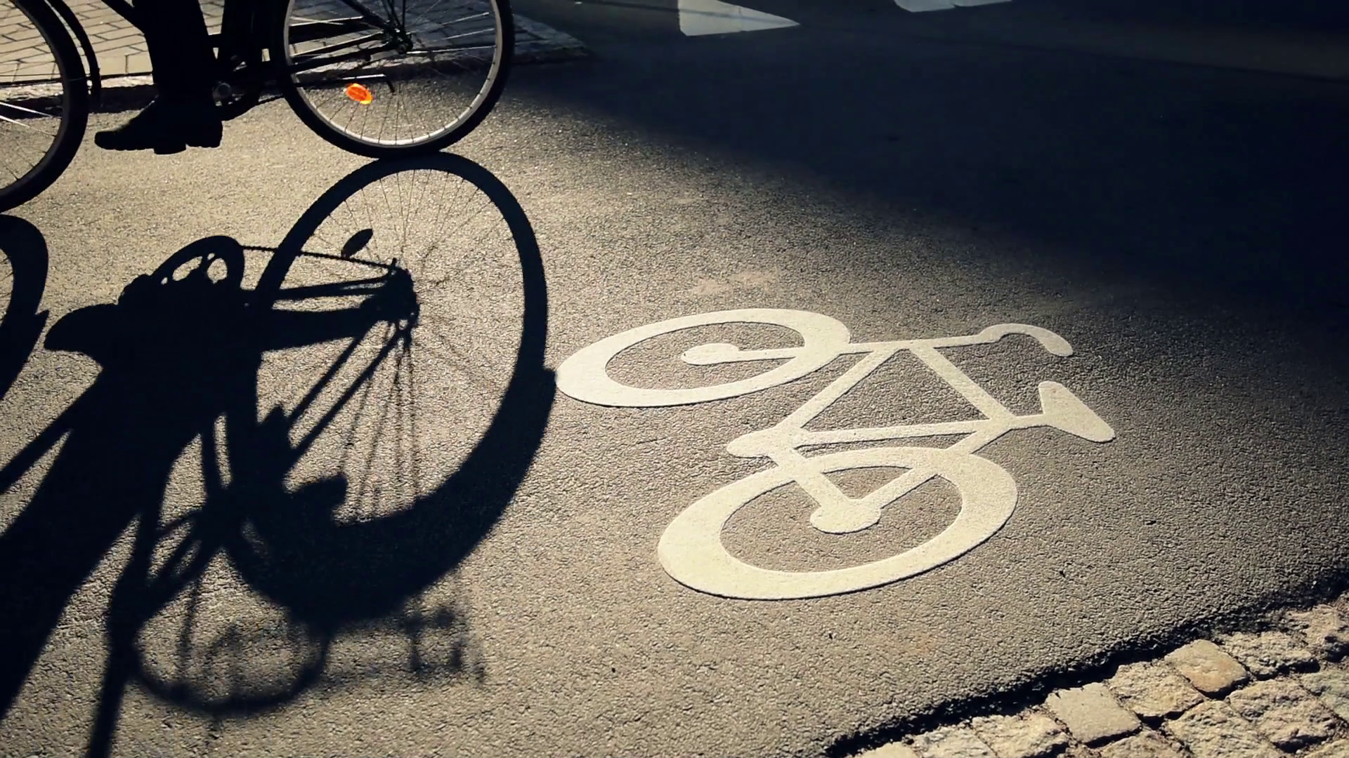 Bicycle ride on urban lane in sunset, shadow of unrecognizable ...