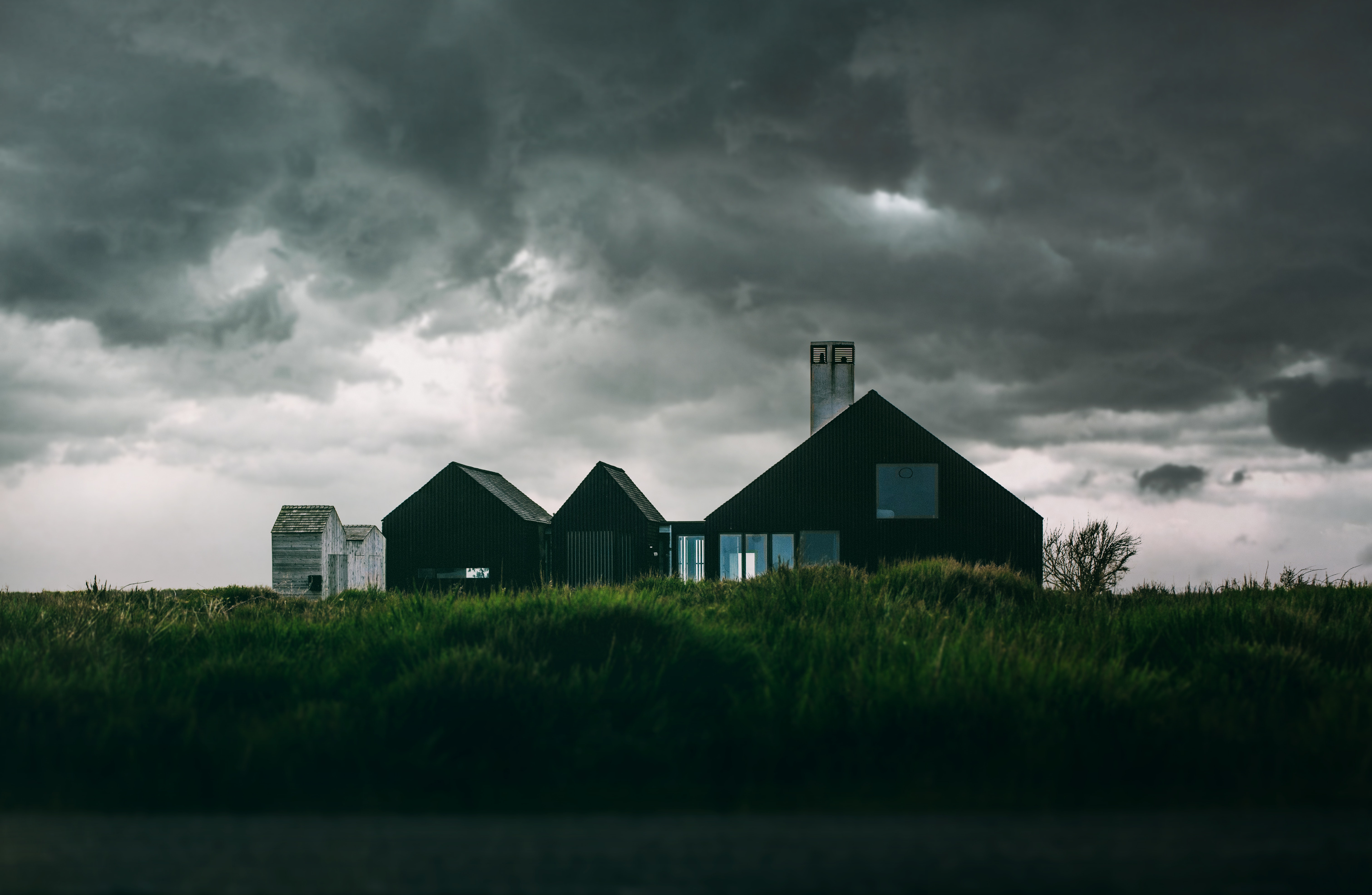 Black and white house under thick clouds photo