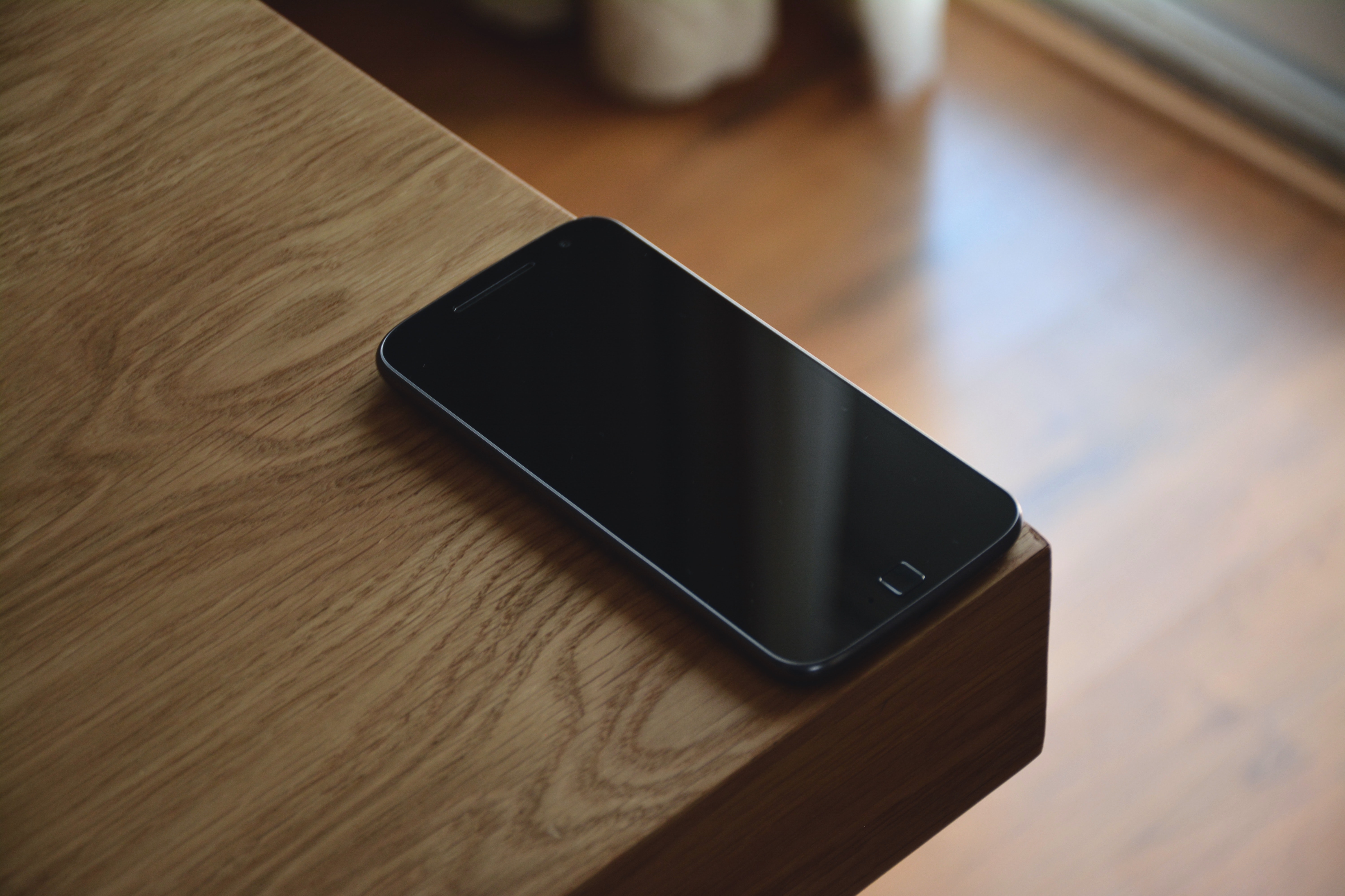 Black android smartphone on corner table photo