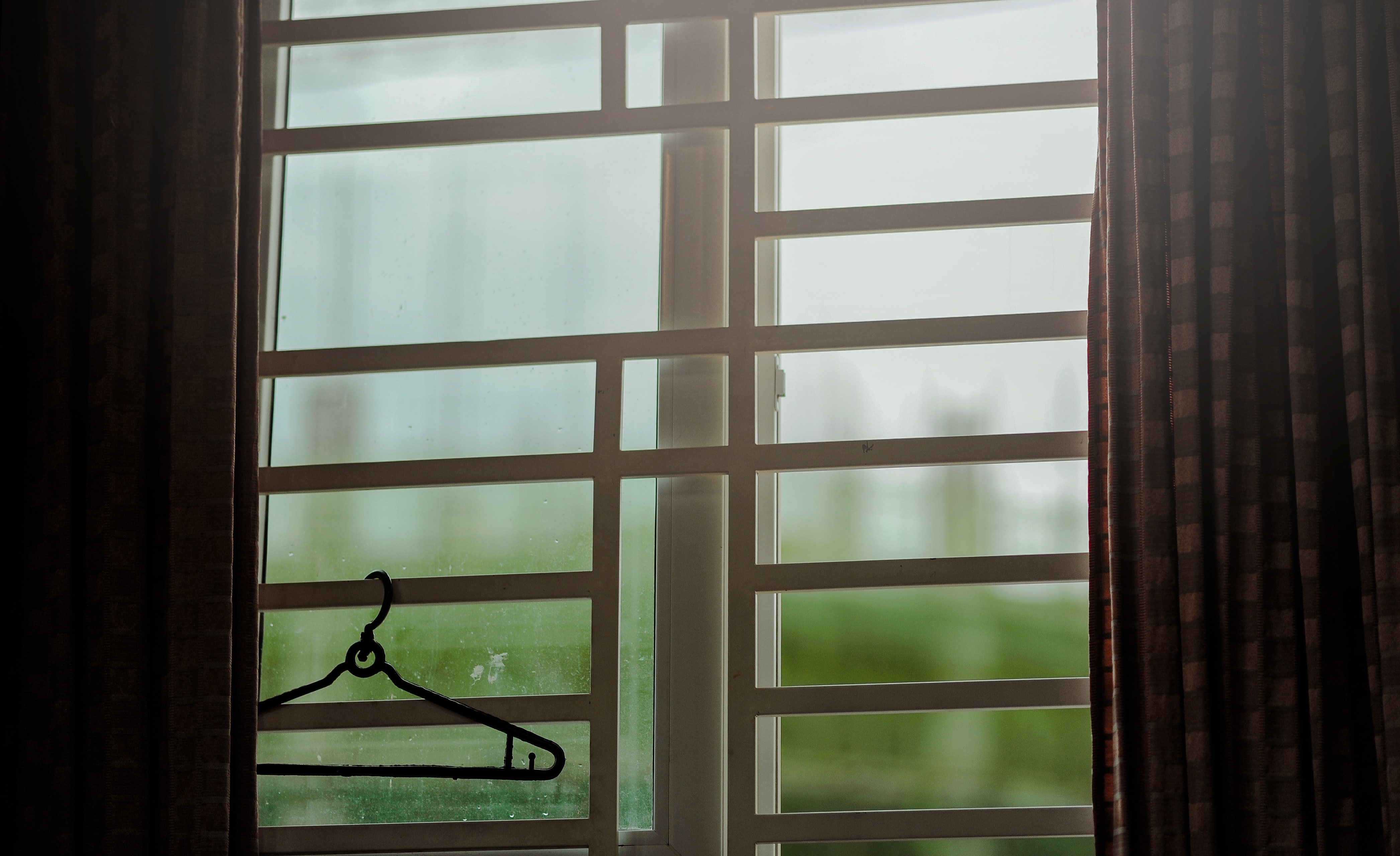 Black clothes hanger hanged on window photo