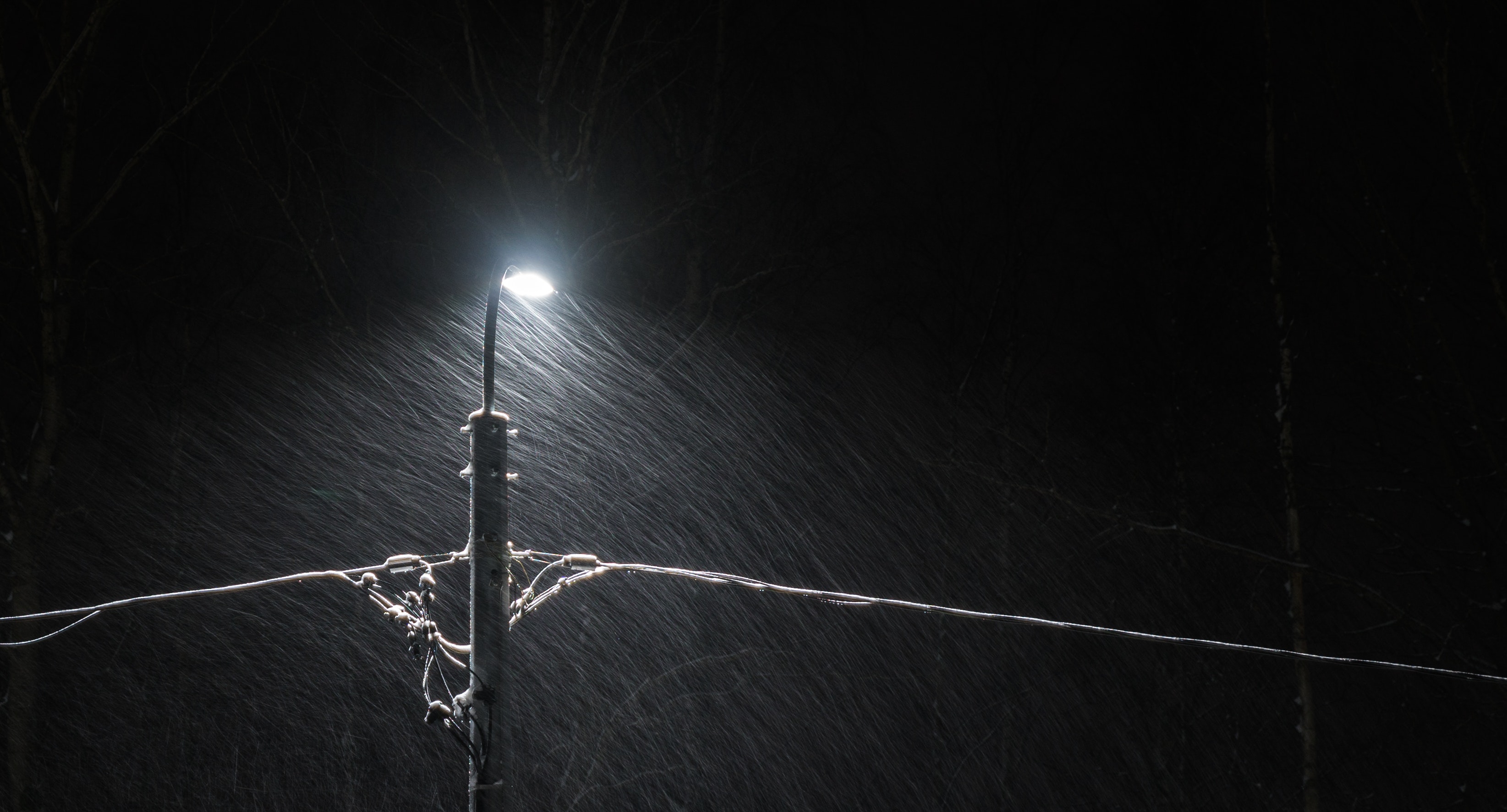 Black electric lamp post with lighted lamp during nighttime photo