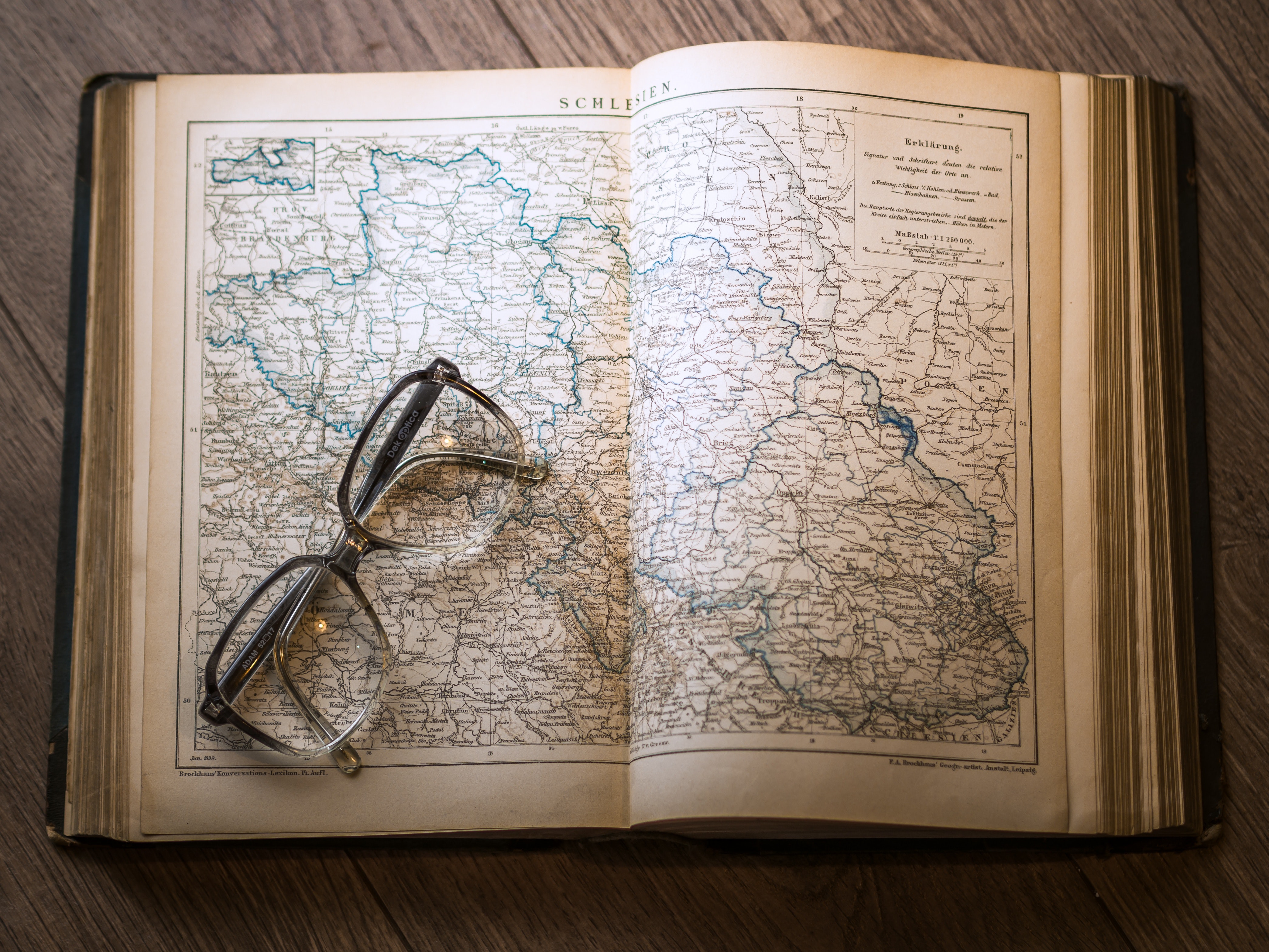 Black framed eyeglasses map in book photo