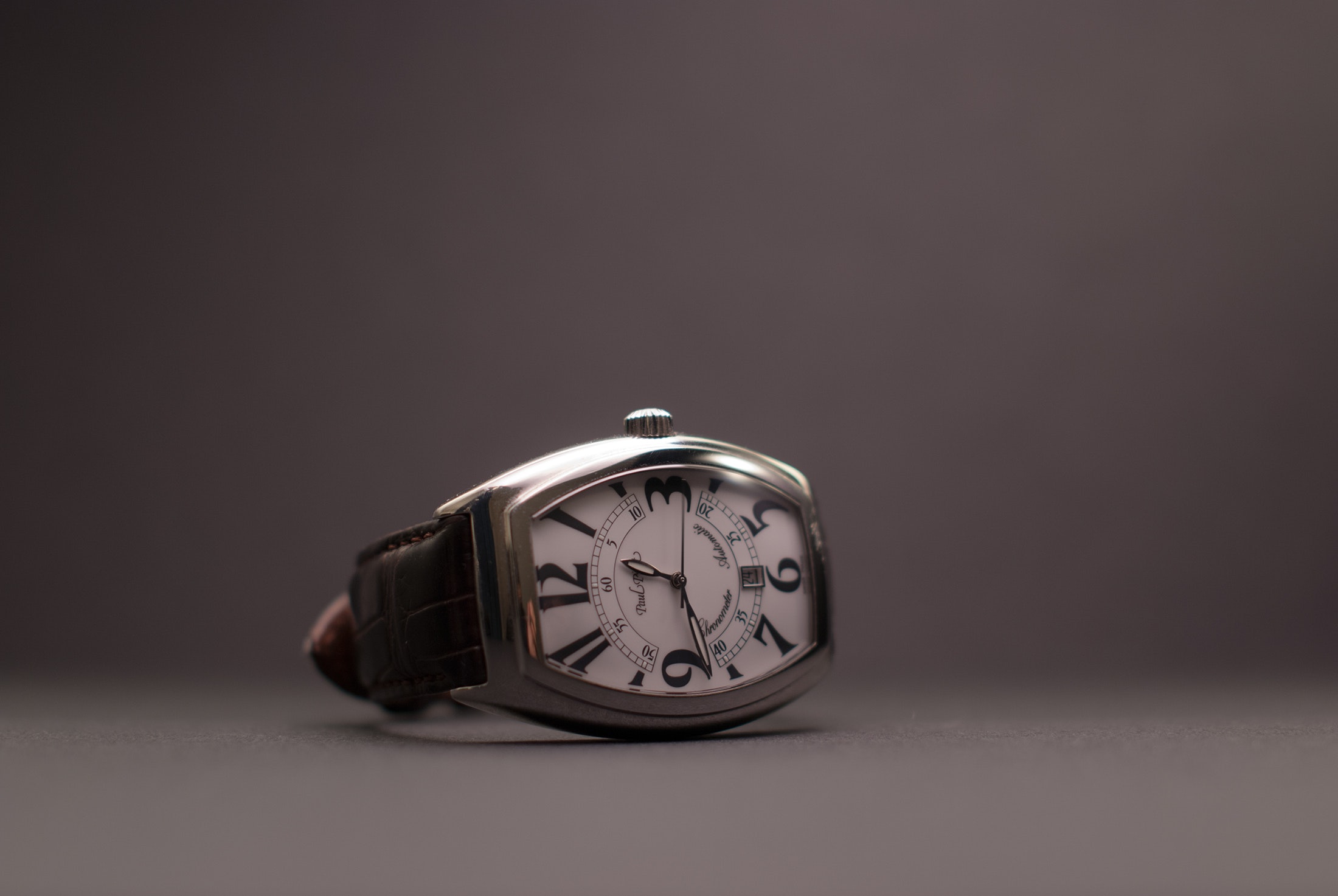 Black leather strap silver rectangular analog watch photo