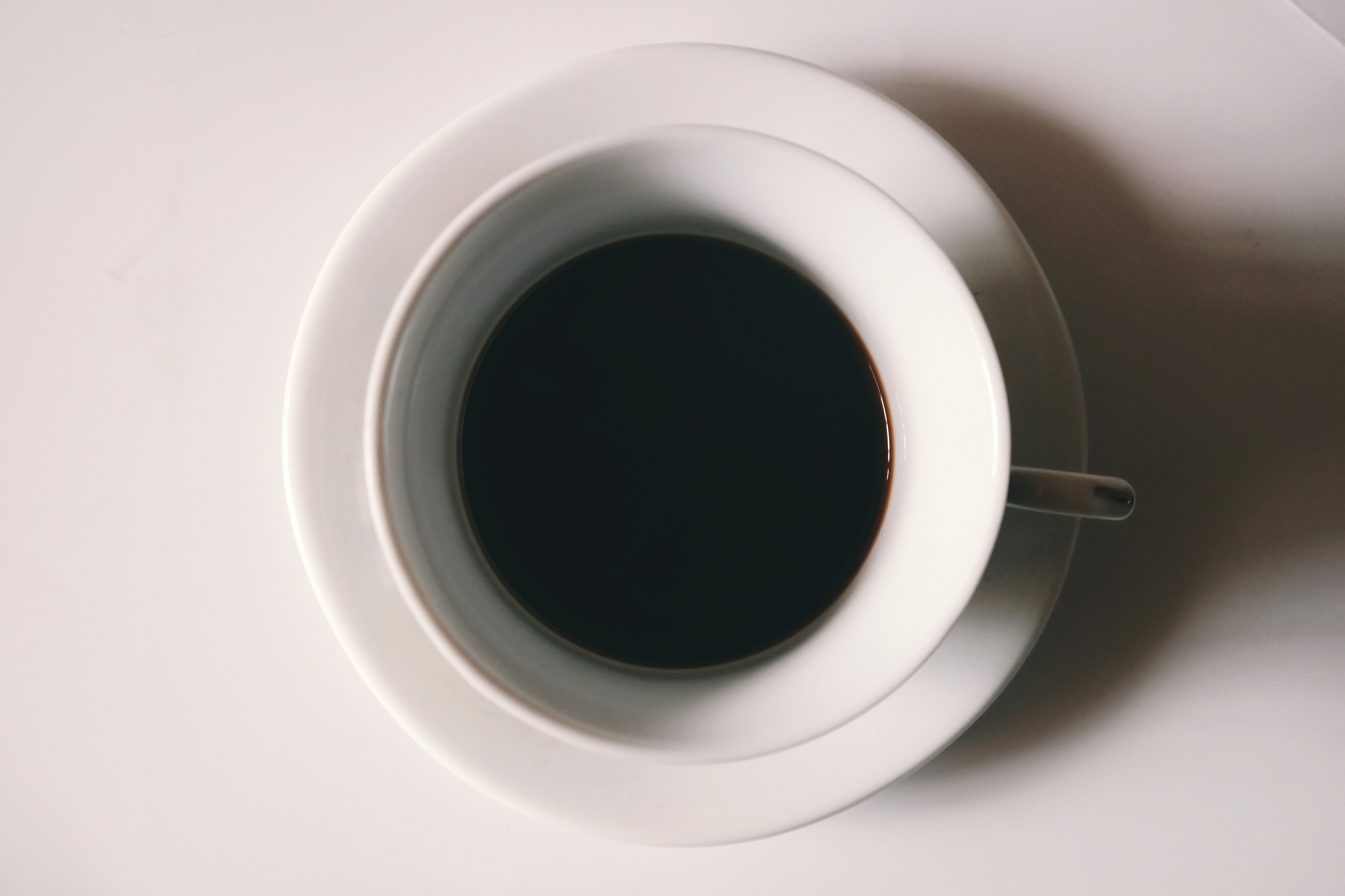 Black liquid in white ceramic mug photo