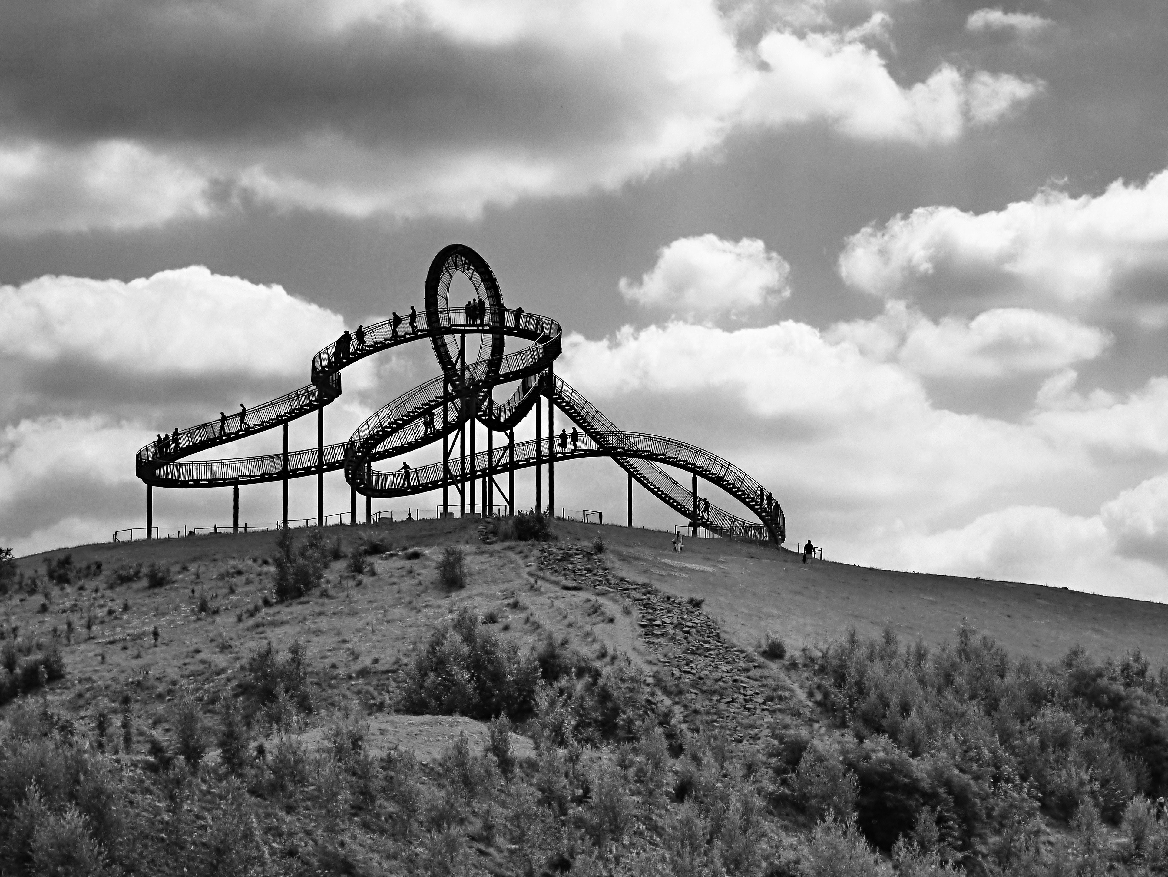 Black roller coaster in grey scale photography
