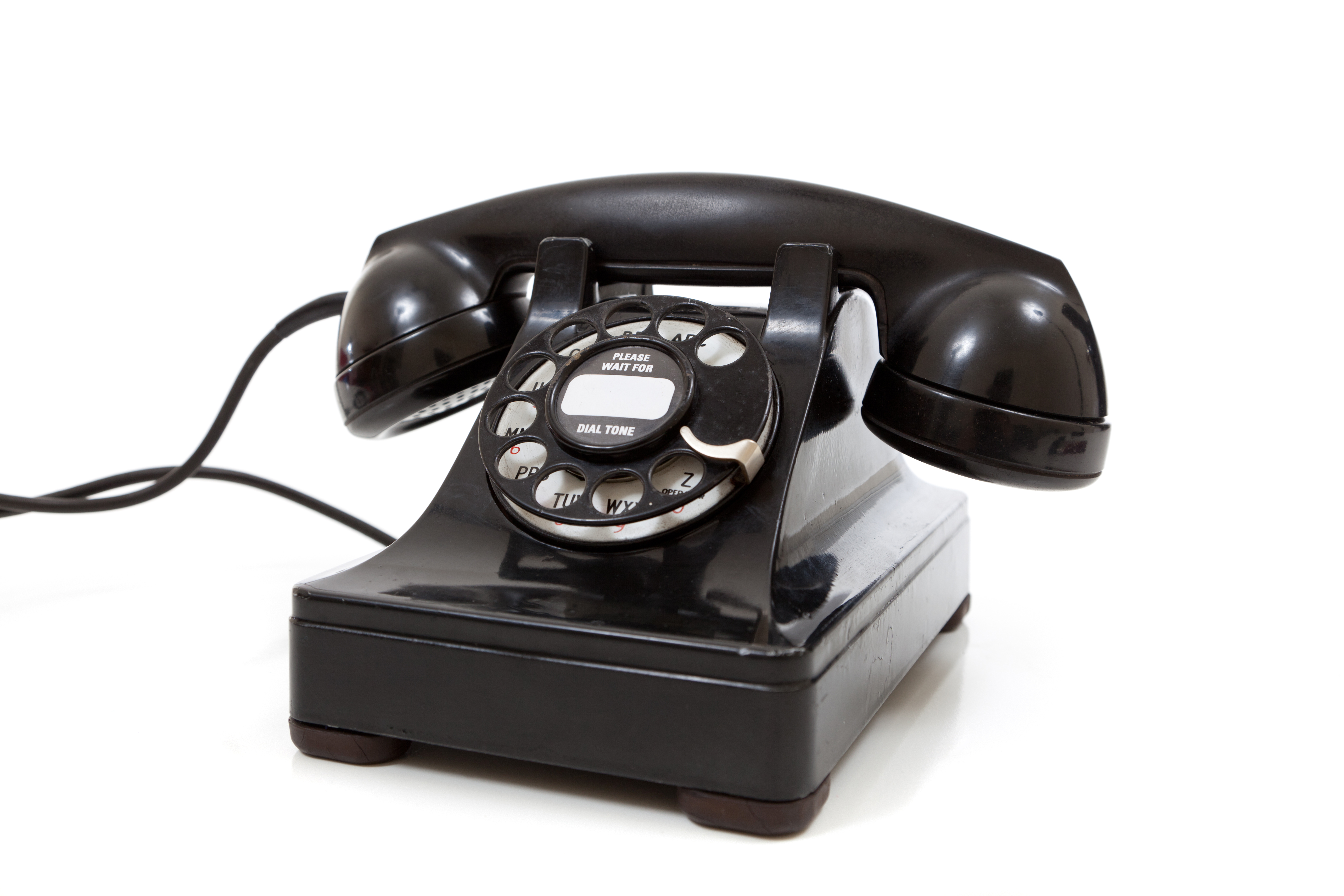 A black vintage rotary phone on a white background -