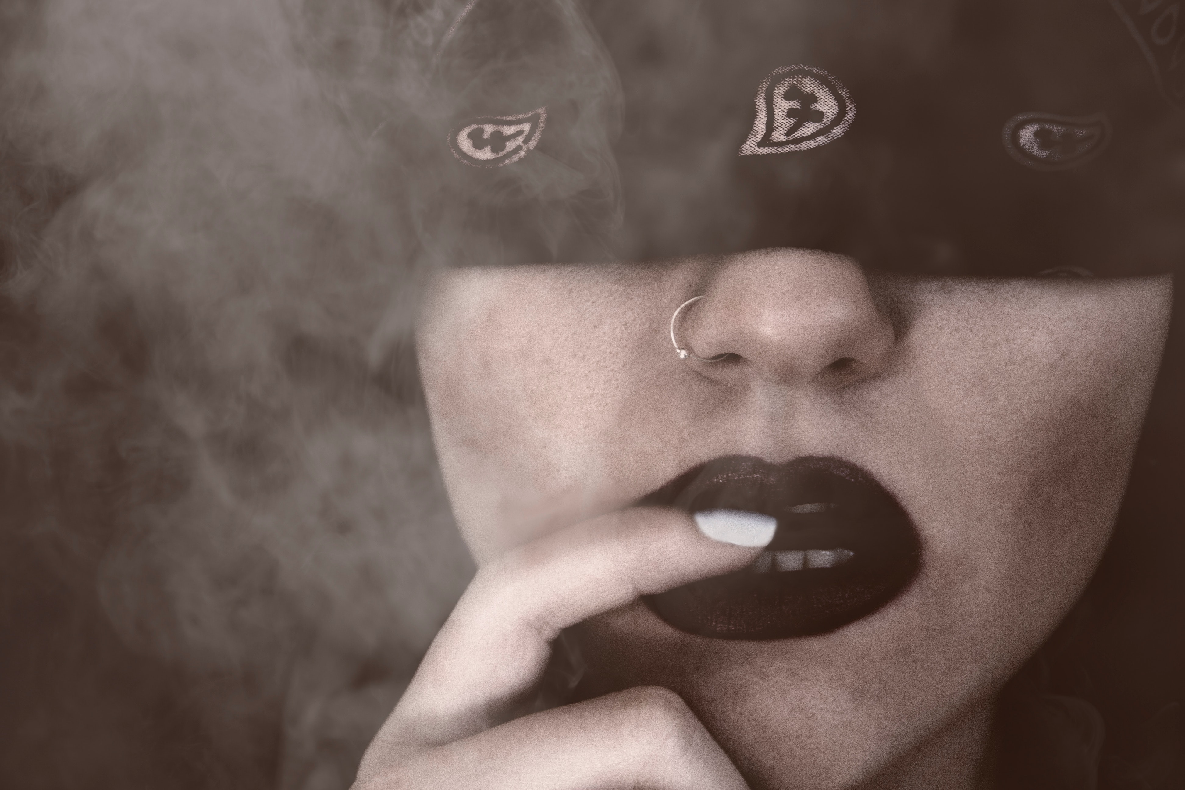 Blindfolded woman with finger on lips grayscale portrait photo