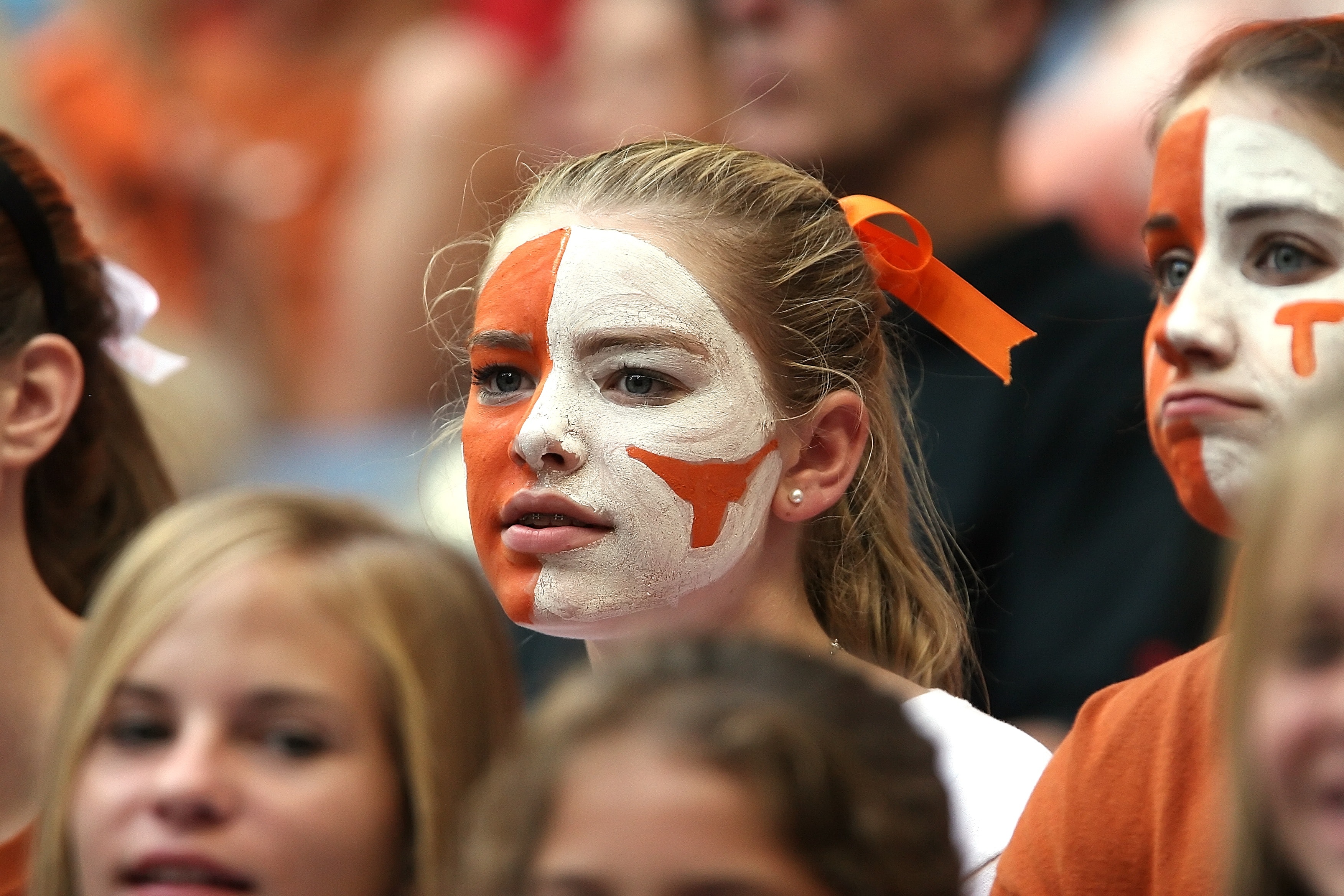 Blond hair woman with orange and white face paint photo