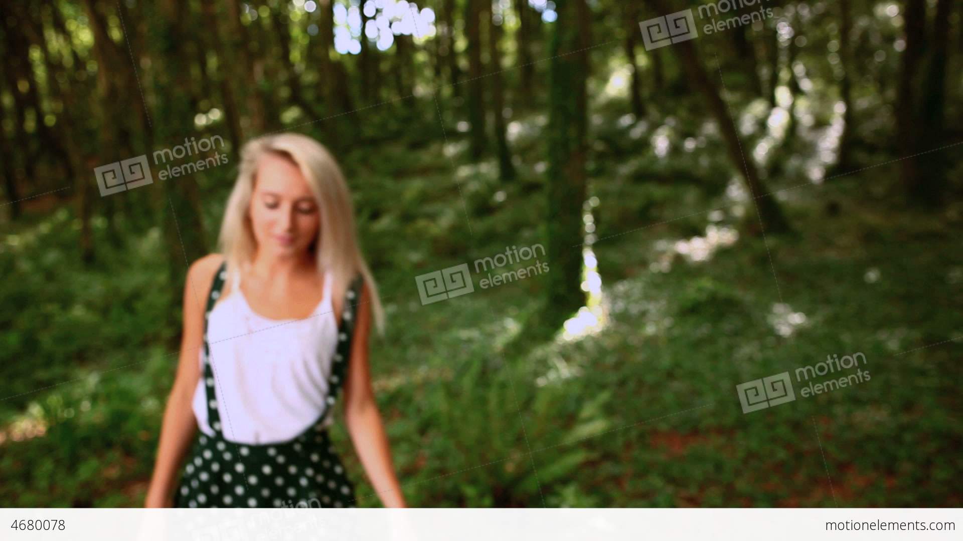 Attractive Blonde Walking Through Forest Stock video footage | 4680078