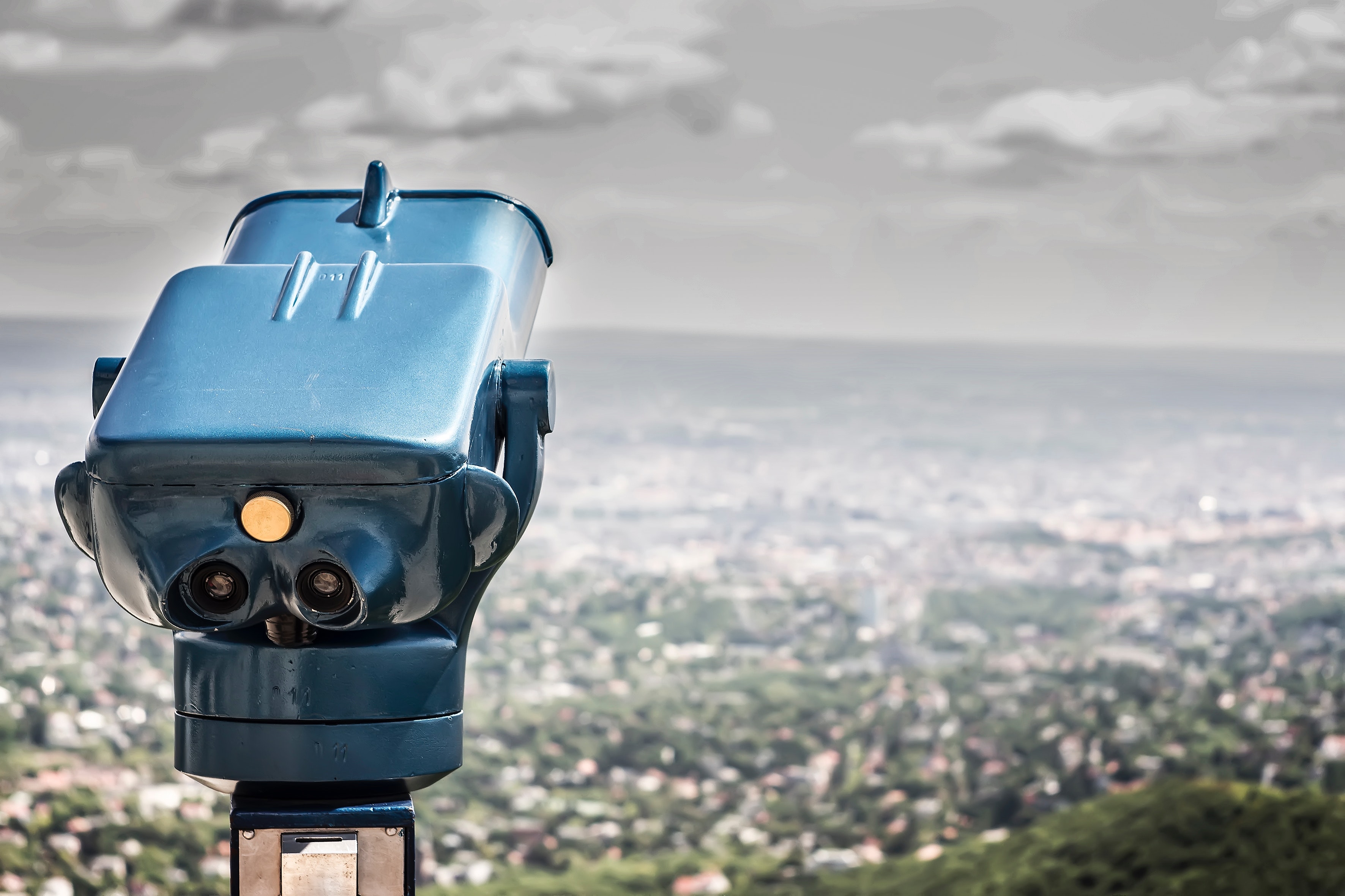 Blue coin operated binocular with city view during daytime photo