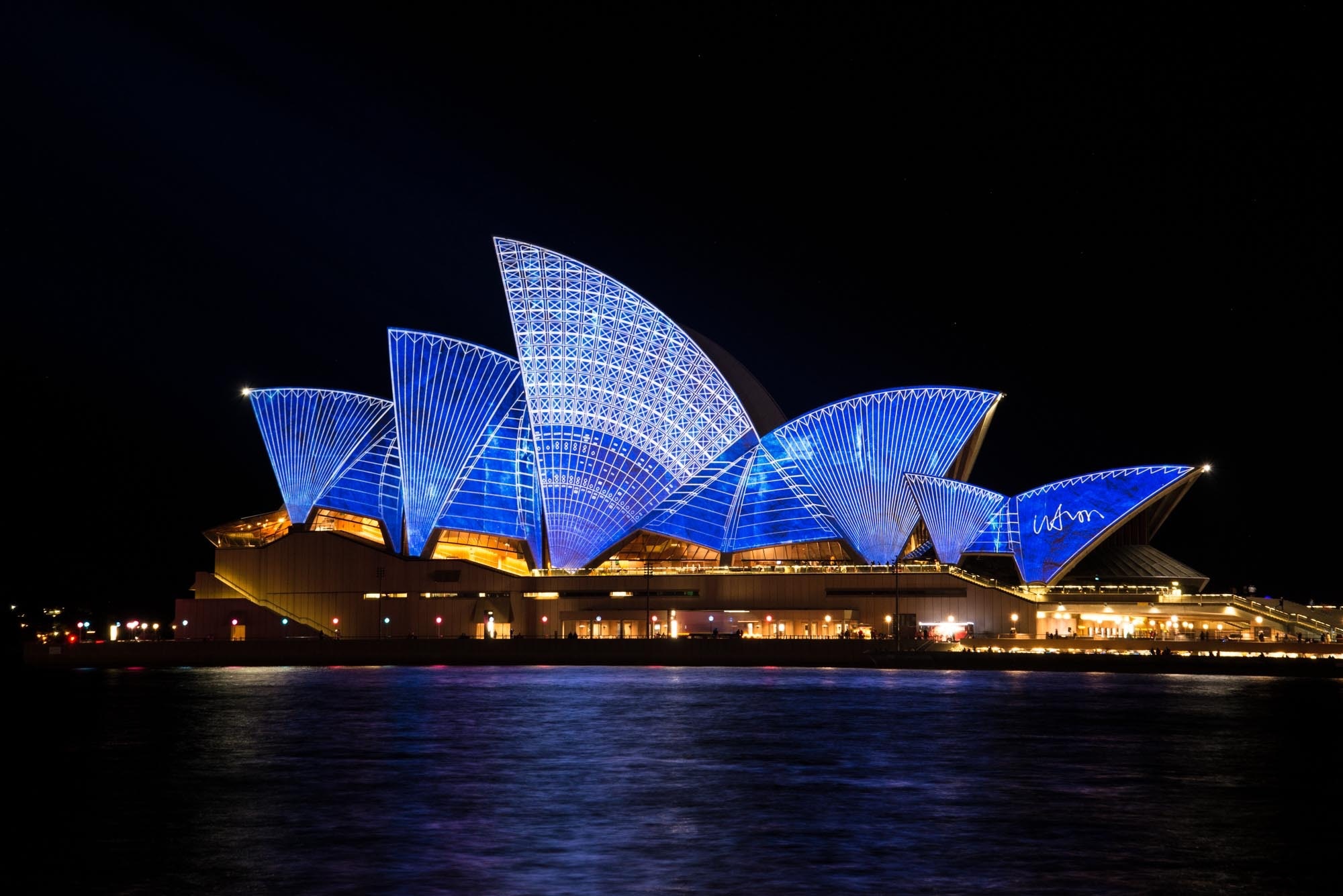 Blue lighted sydney opera house during nighttime photo