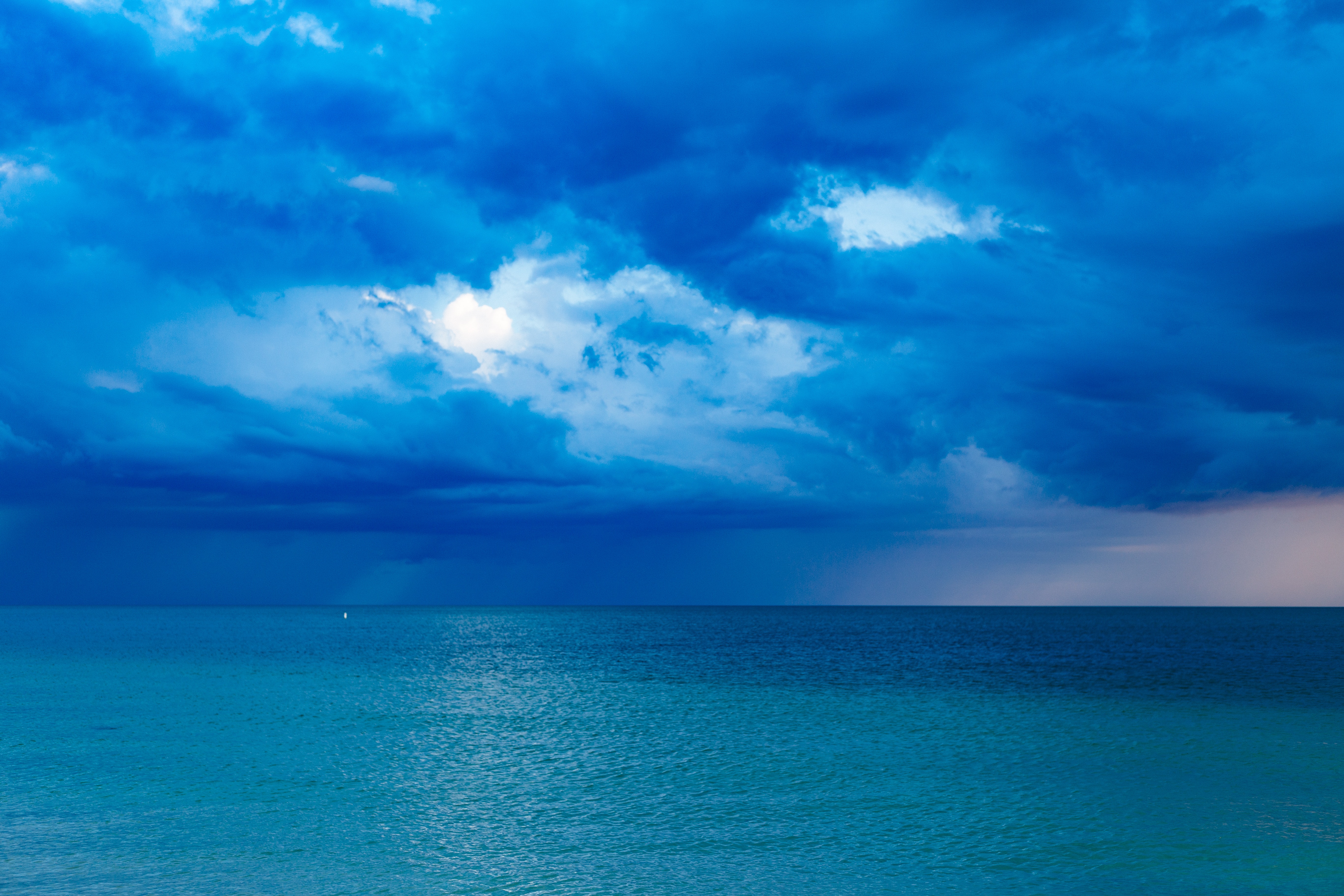 Blue ocean with cloudy sky photo